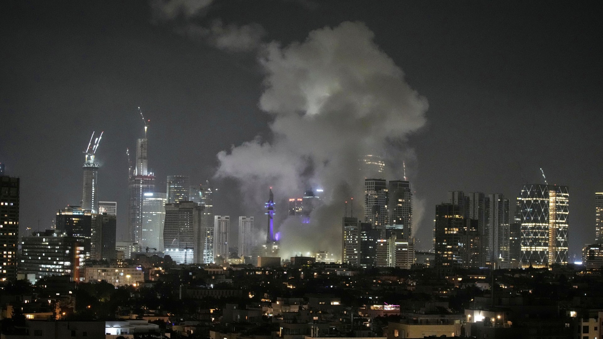 city skyline with lights turned on during night time
