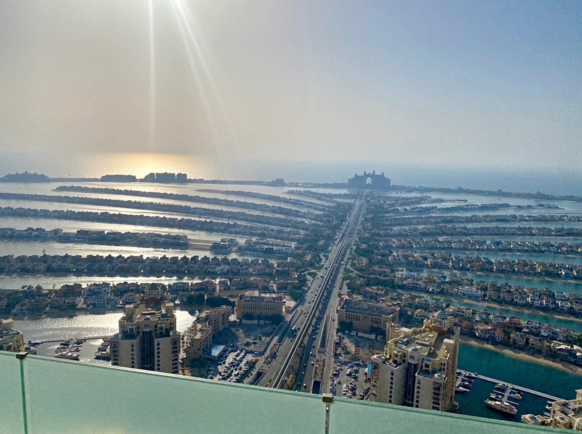 a person is walking in the desert at sunset