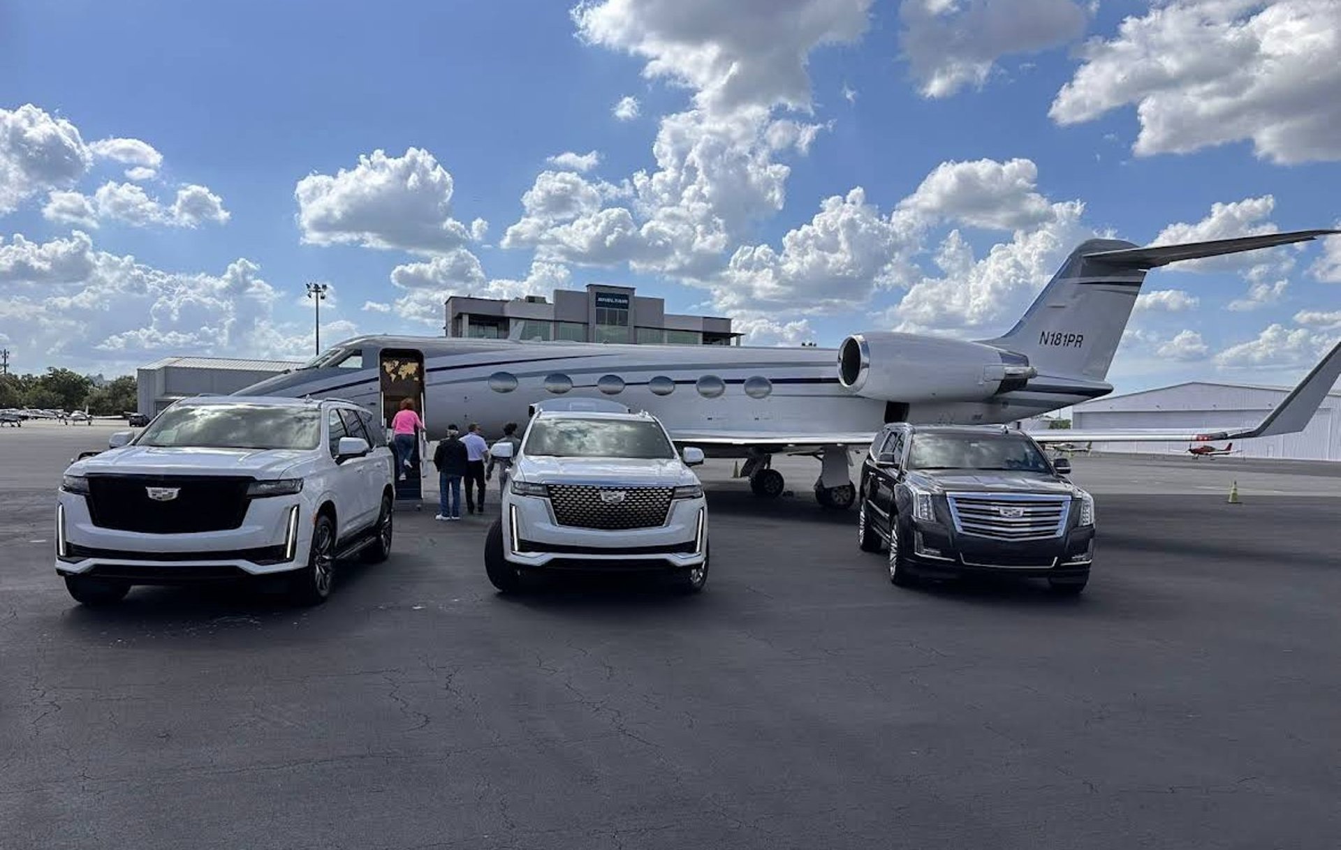 a black suv parked in front of a stone building