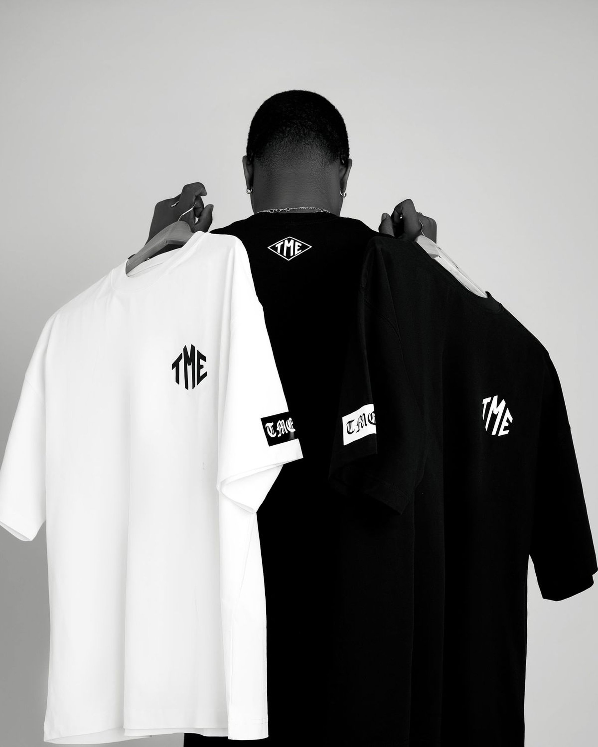 man in white pullover hoodie standing on road during daytime