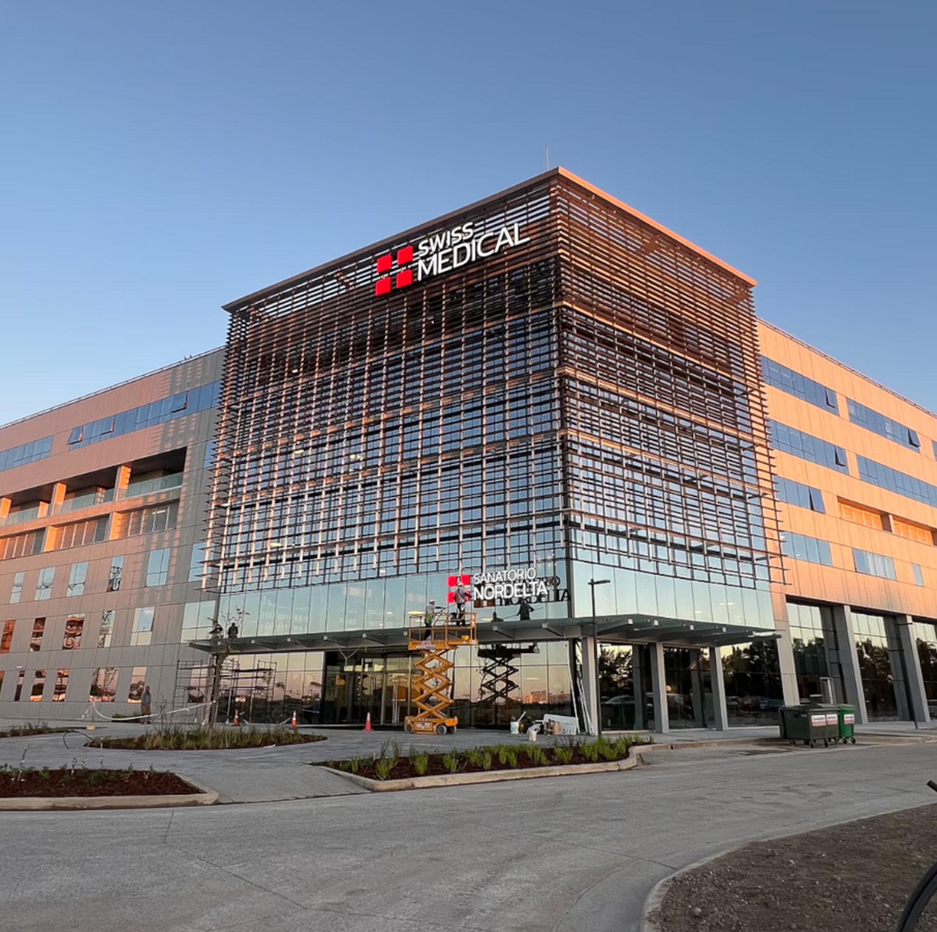 an abstract photo of a curved building with a blue sky in the background