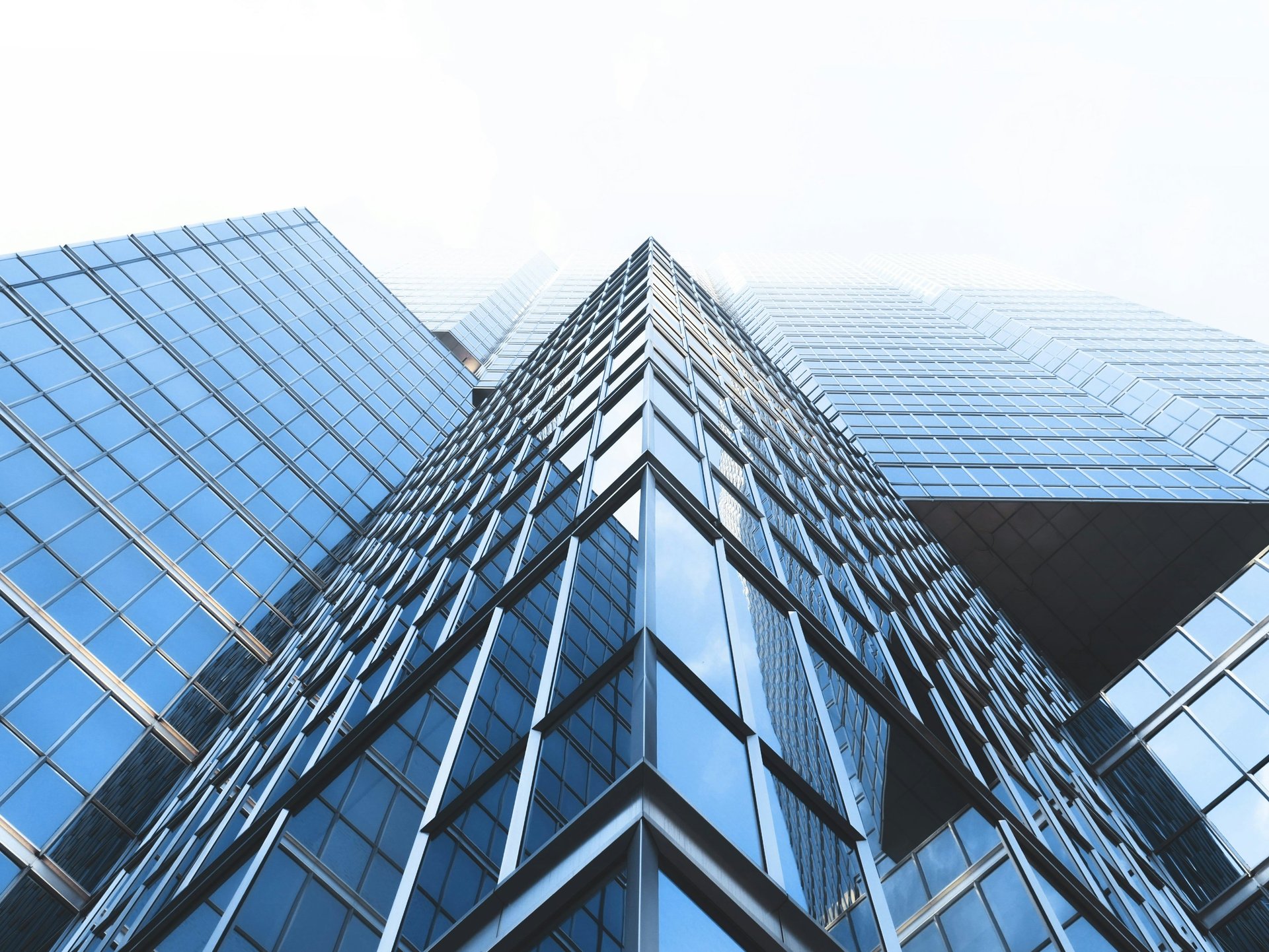 an abstract photo of a curved building with a blue sky in the background