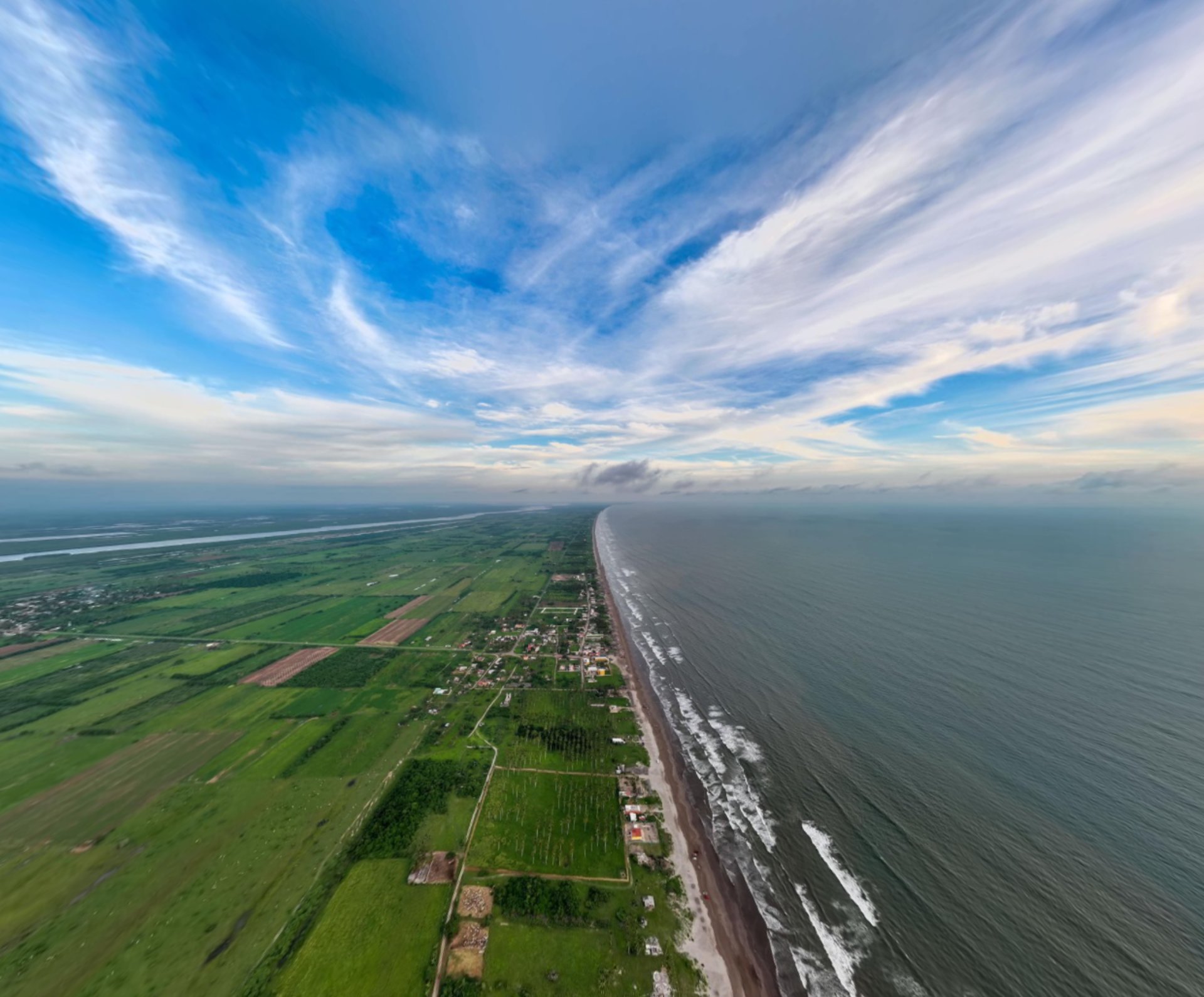 an abstract photo of a curved building with a blue sky in the background