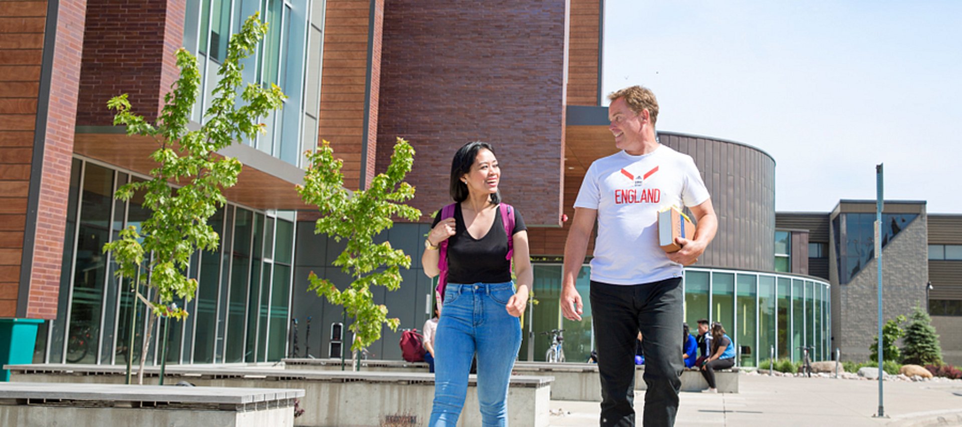 A person walks toward a university building.