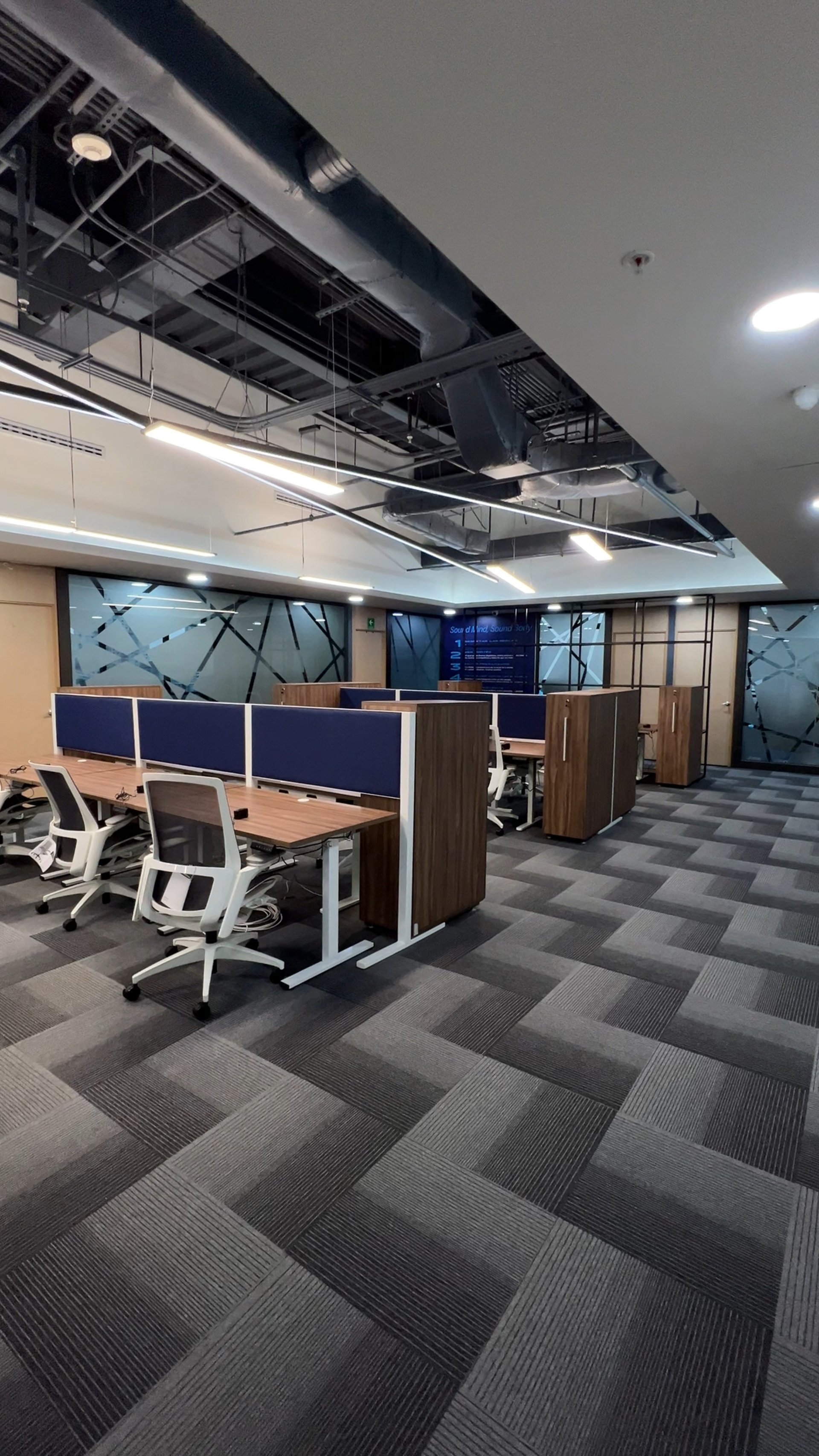 an abstract photo of a curved building with a blue sky in the background