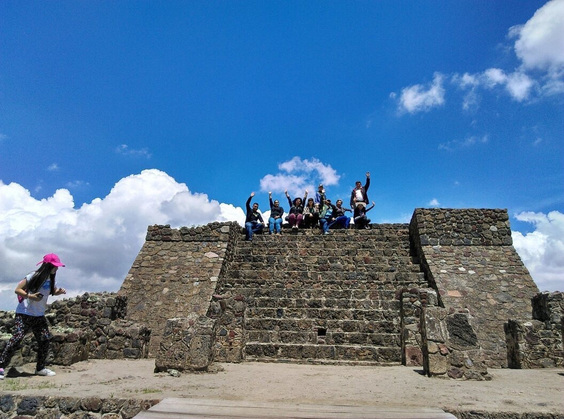 an abstract photo of a curved building with a blue sky in the background