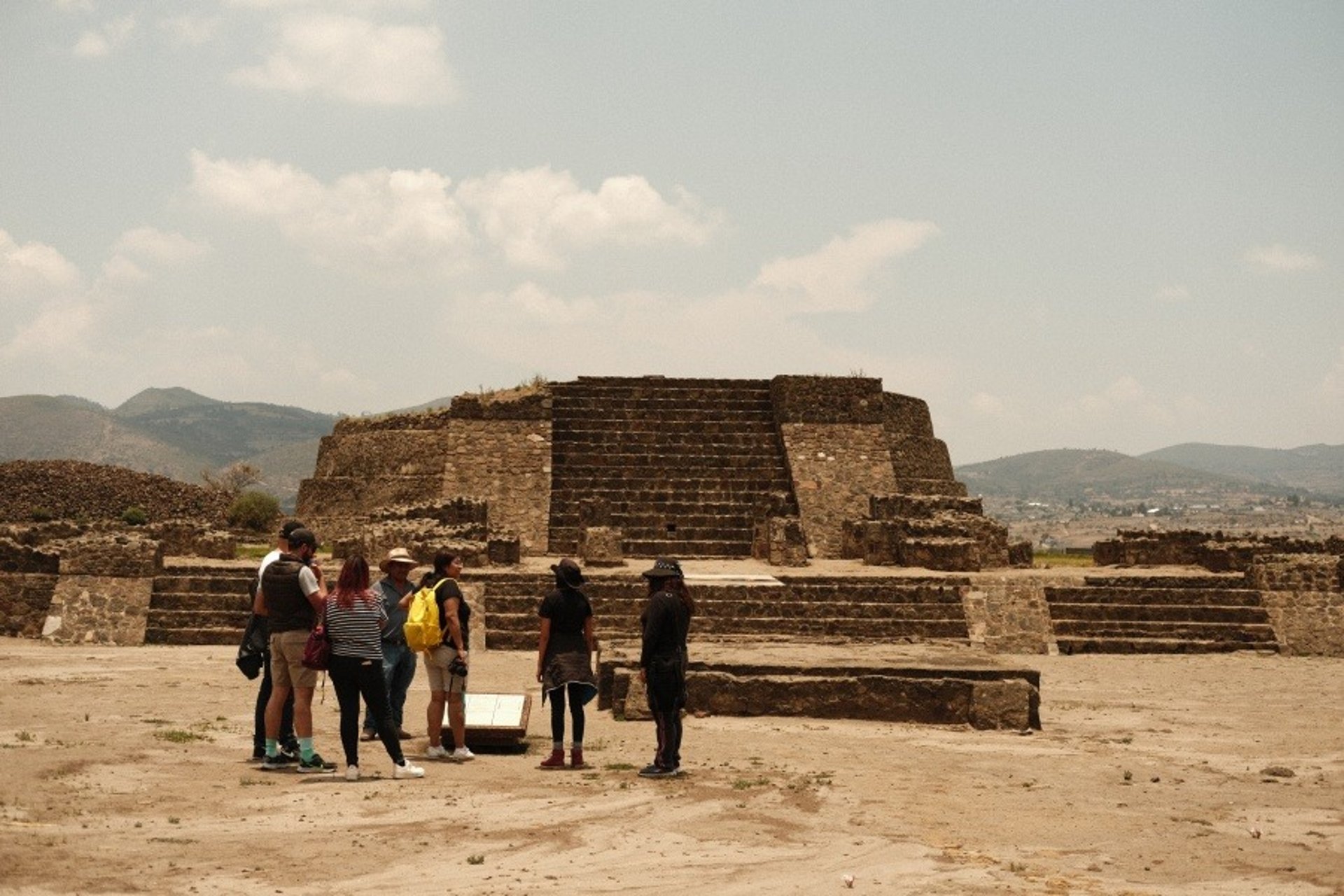 an abstract photo of a curved building with a blue sky in the background