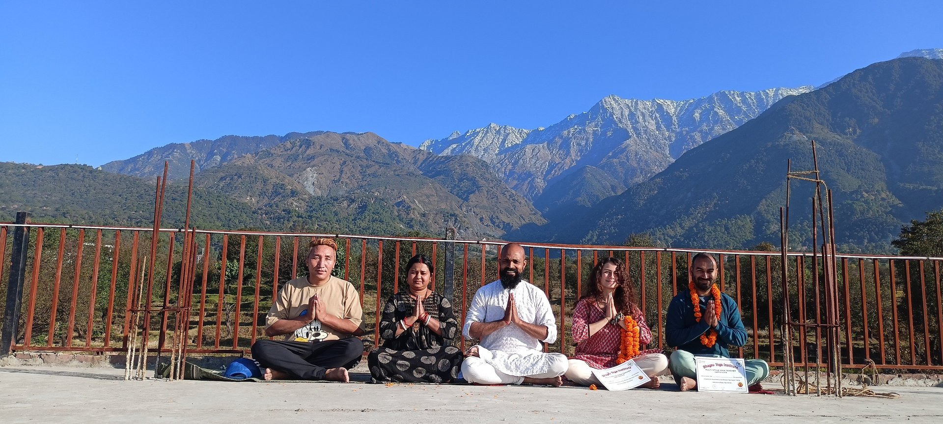 a buddha statue sitting in front of a body of water