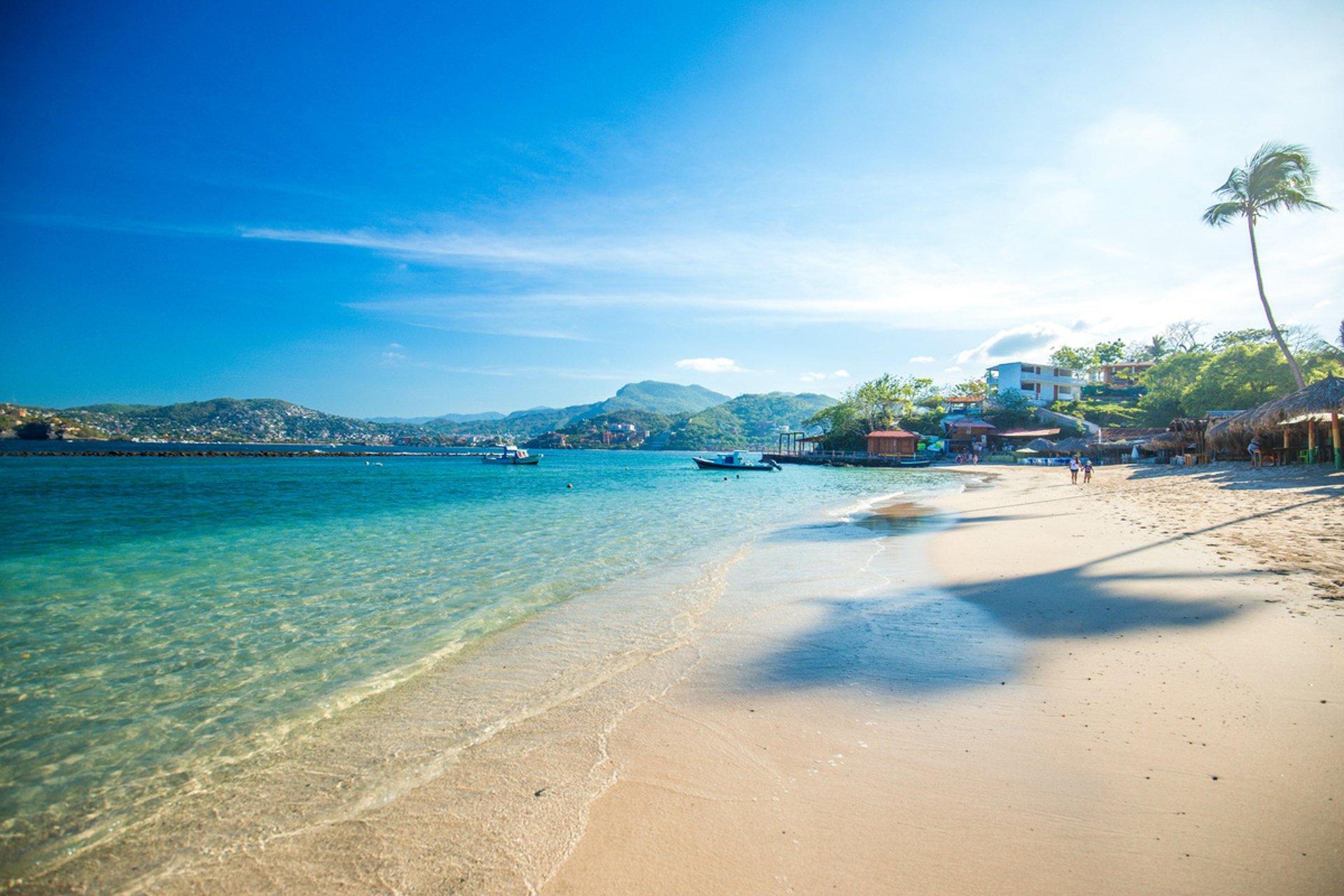 brown rock formation near body of water during daytime
