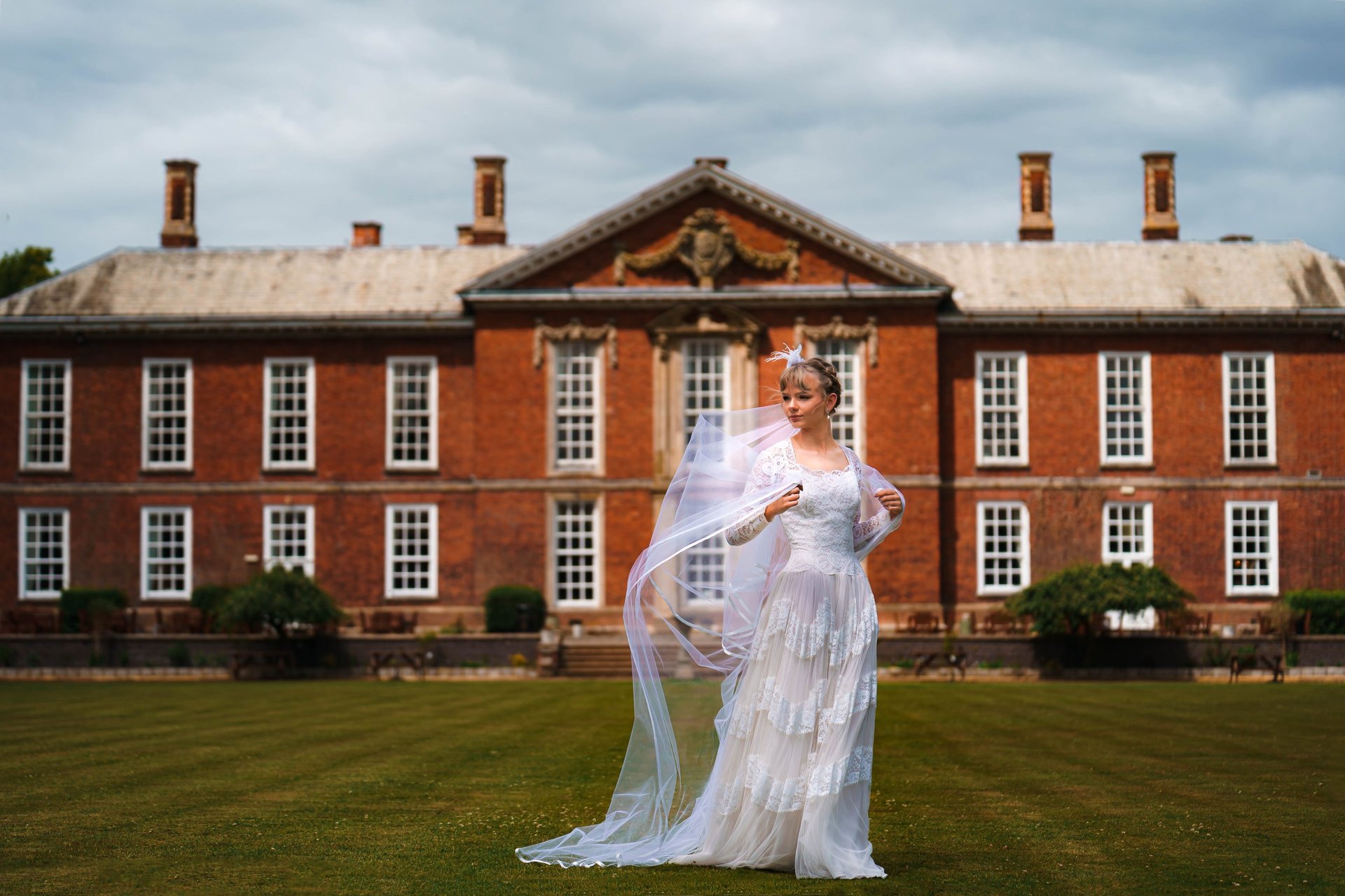 woman wearing yellow long-sleeved dress under white clouds and blue sky during daytime