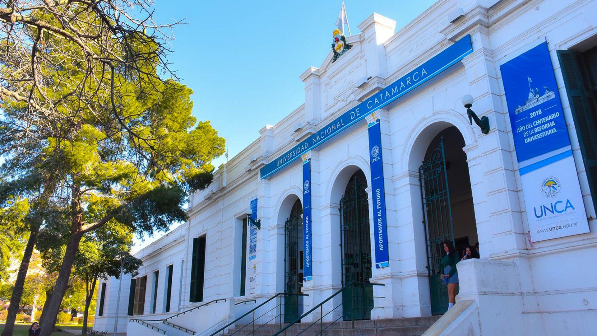 woman wearing yellow long-sleeved dress under white clouds and blue sky during daytime