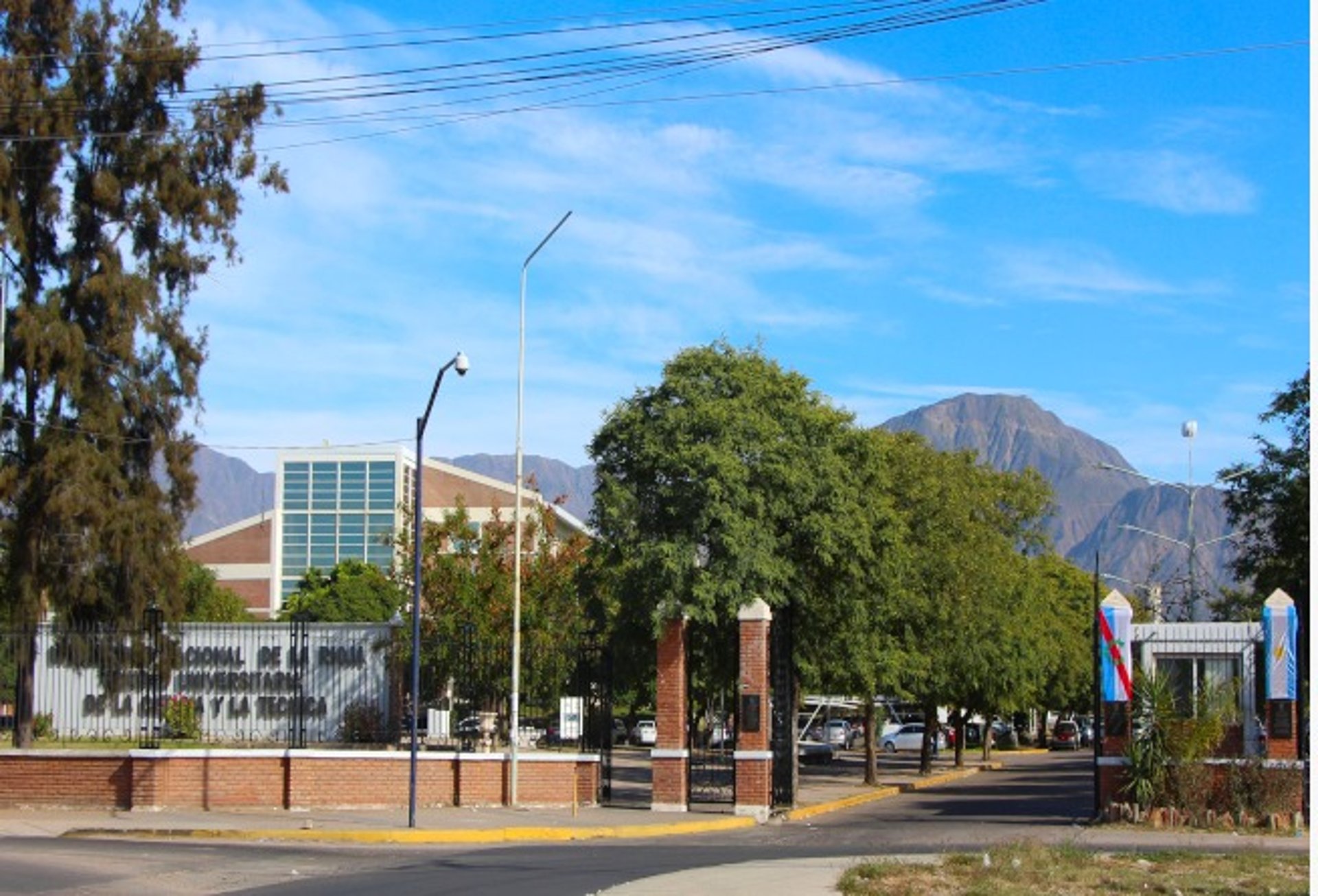 woman wearing yellow long-sleeved dress under white clouds and blue sky during daytime