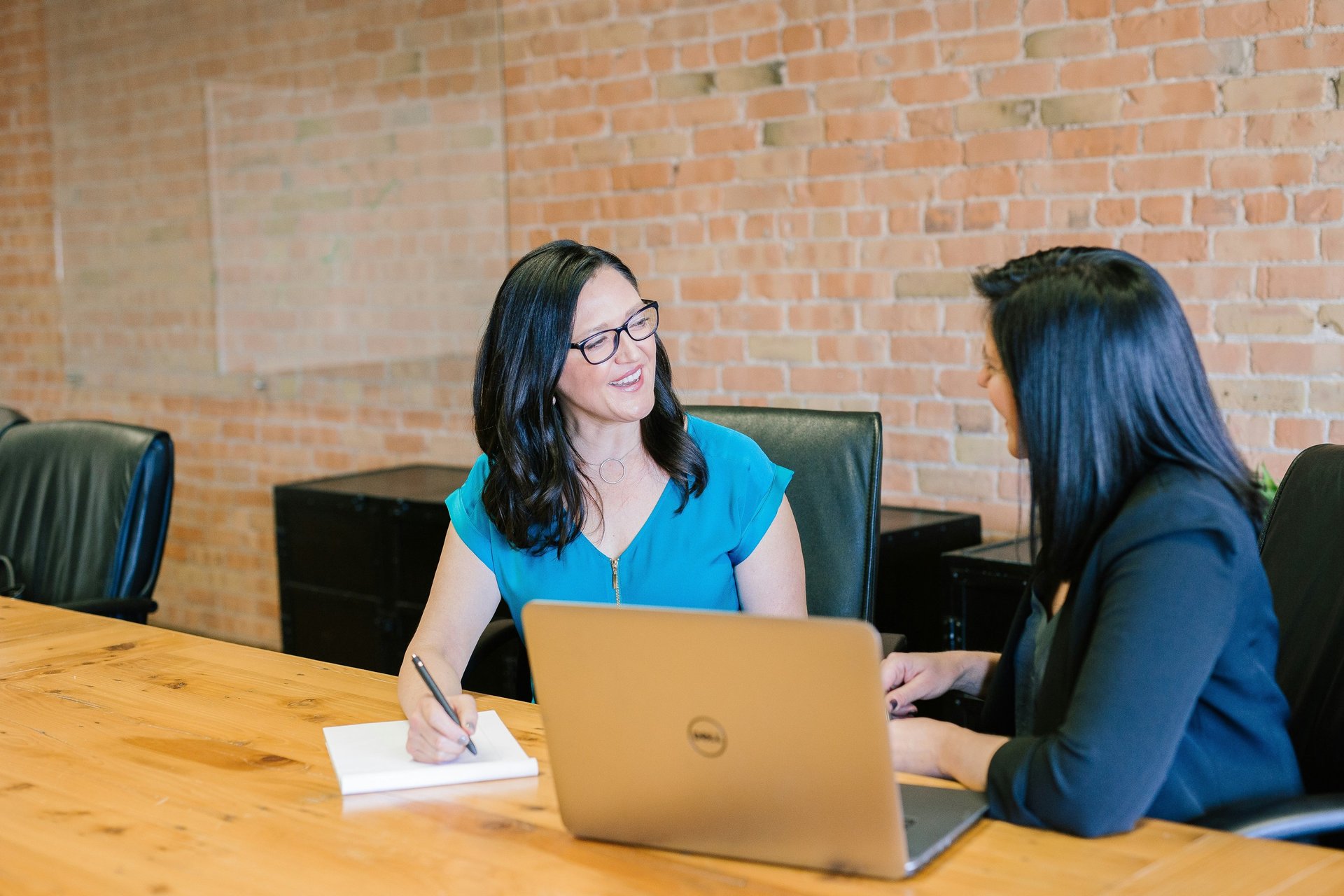two men and four women meeting in office
