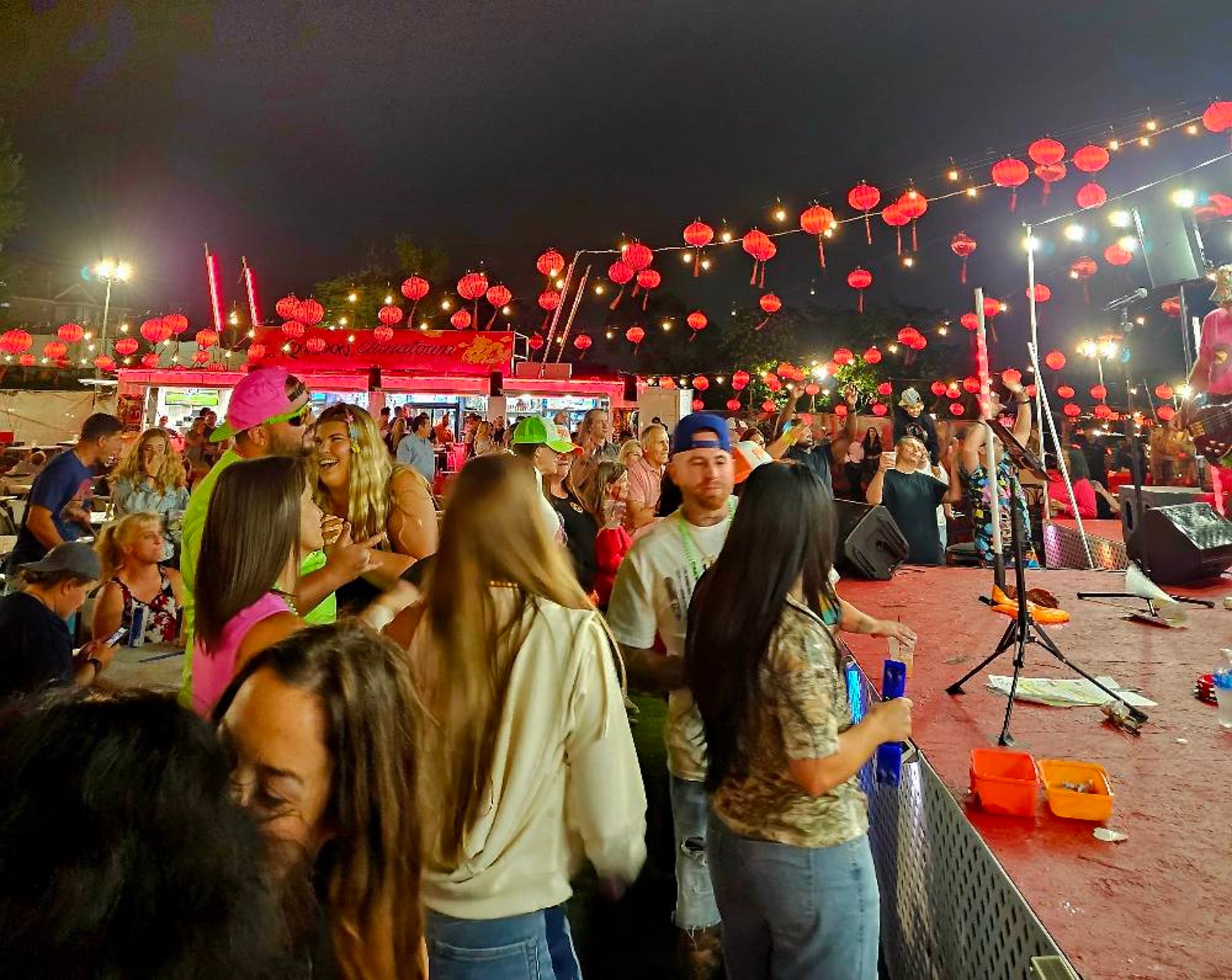 a group of people standing around each other at a party