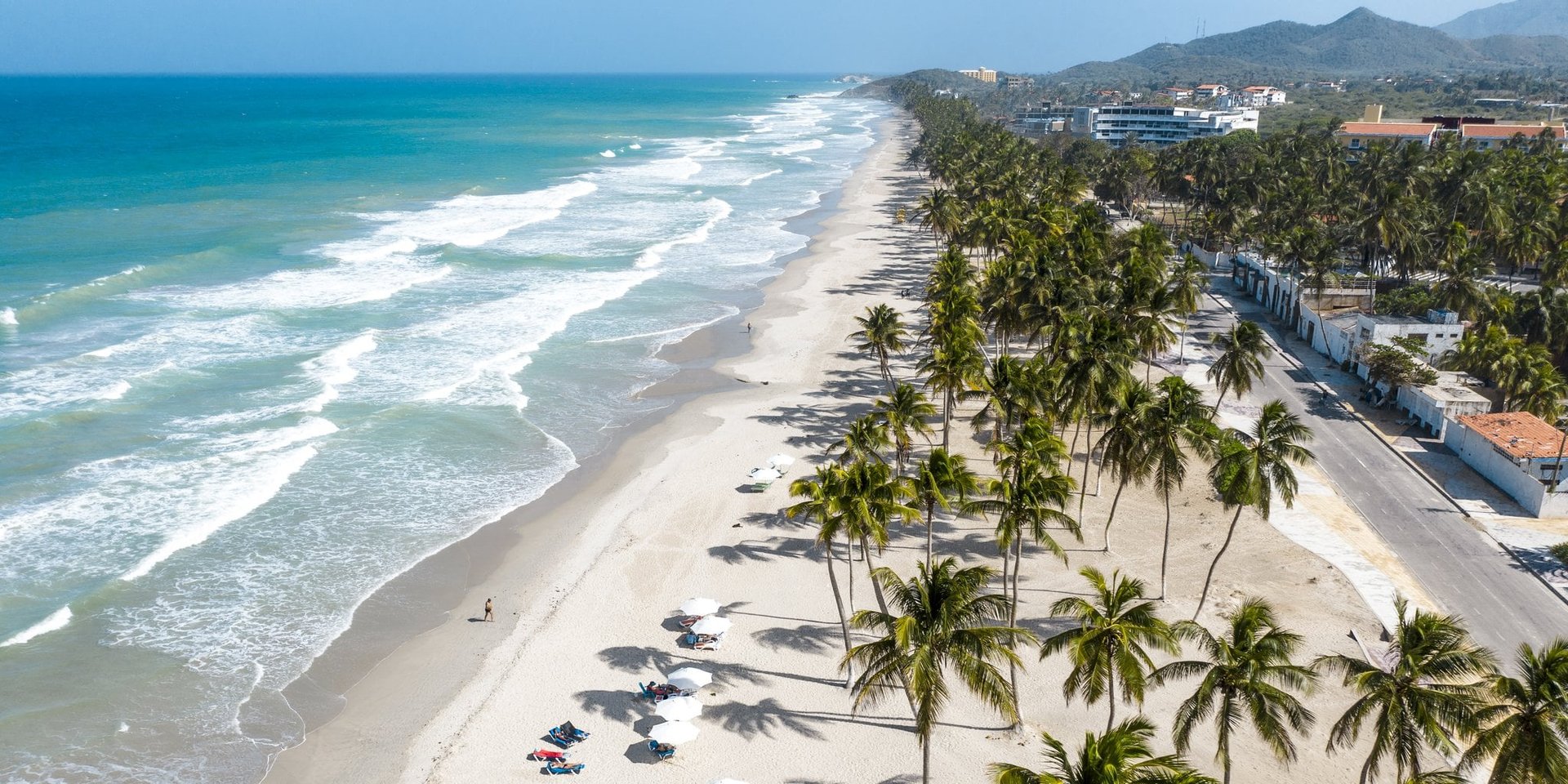 an abstract photo of a curved building with a blue sky in the background
