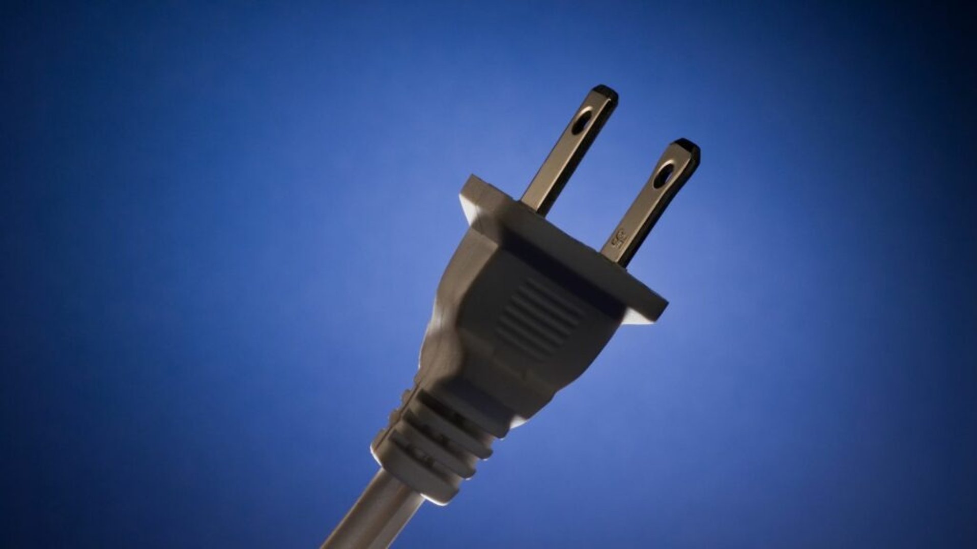 an abstract photo of a curved building with a blue sky in the background