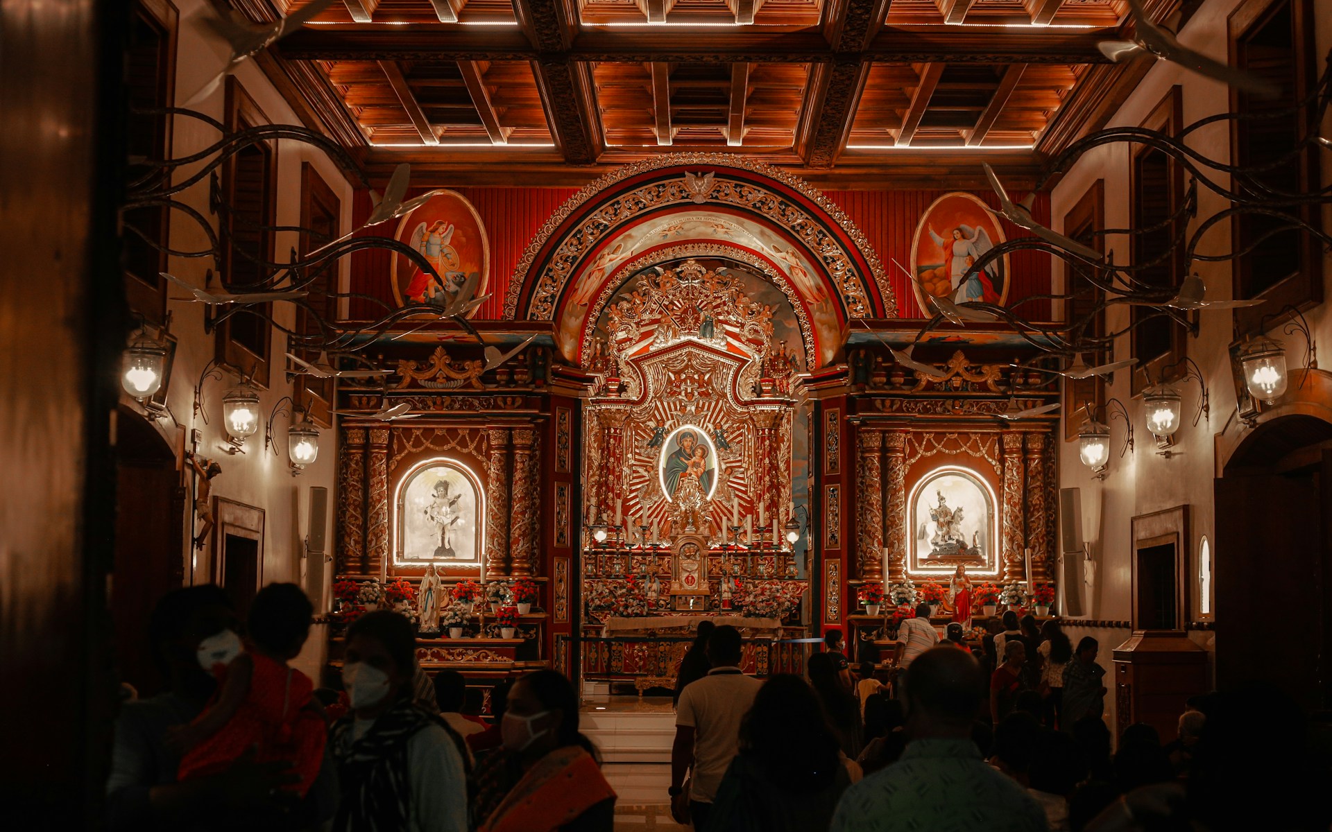 A group of people standing in front of alter of Edappally Church