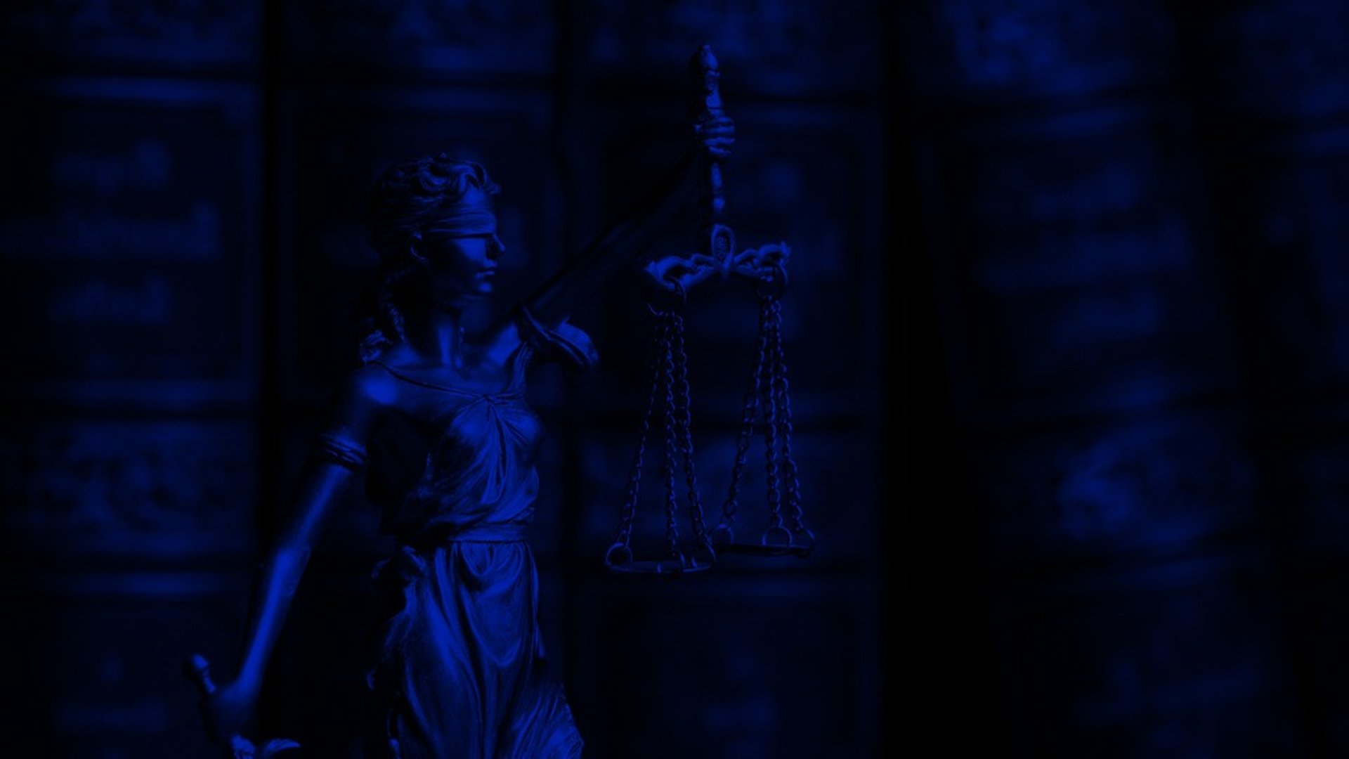 man wearing robe bust figurine near black wall