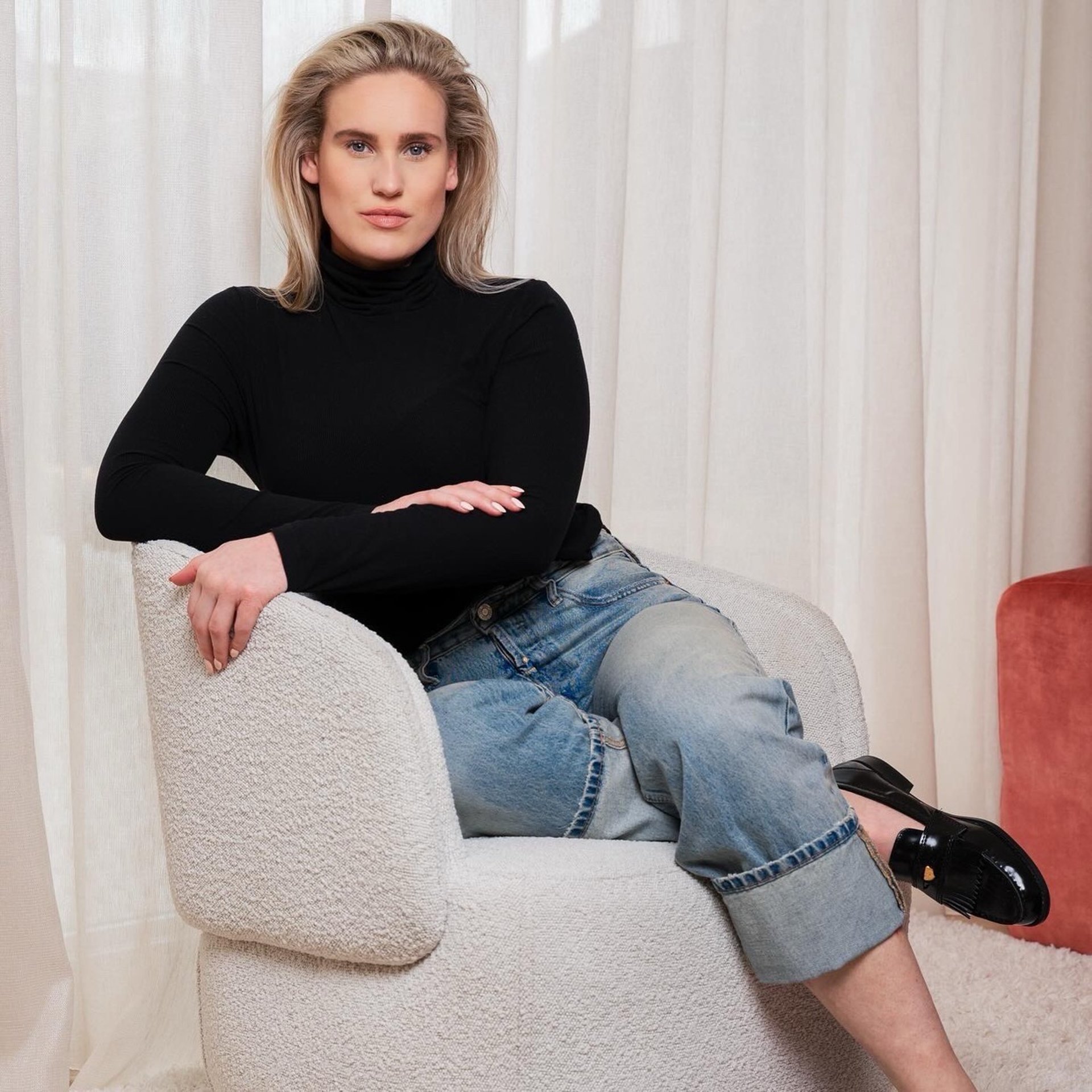 An avocado cut in half with a knife.