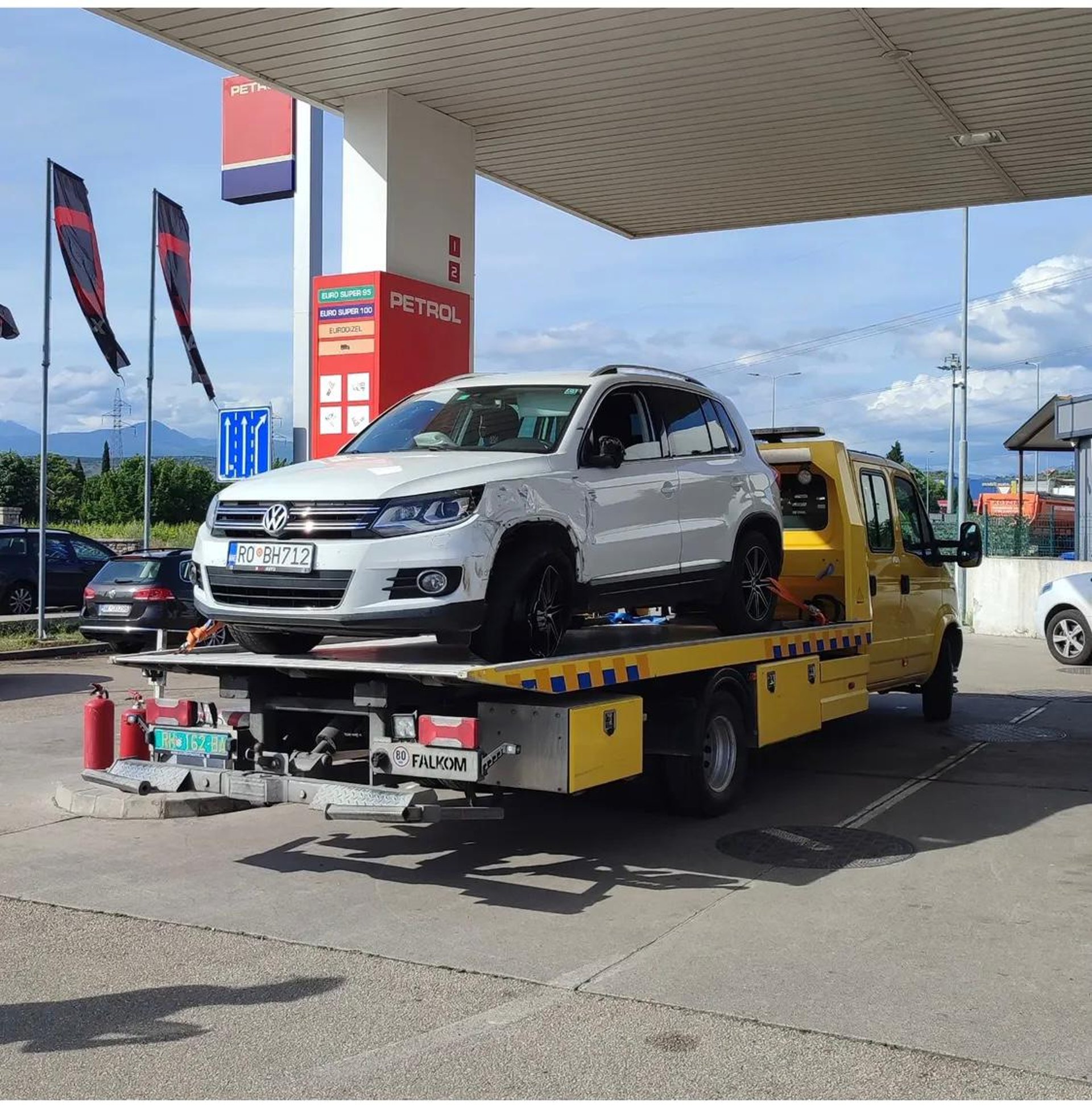 white and black coupe on trailer during daytime