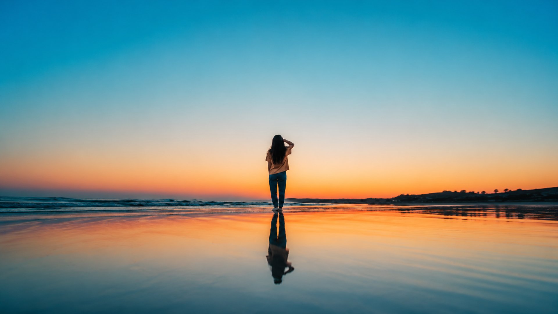 woman standing on sands near shoreline