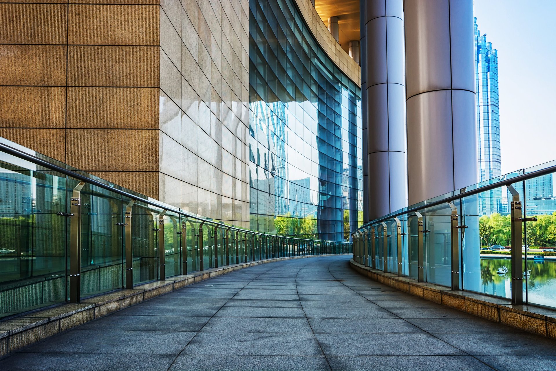 an abstract photo of a curved building with a blue sky in the background