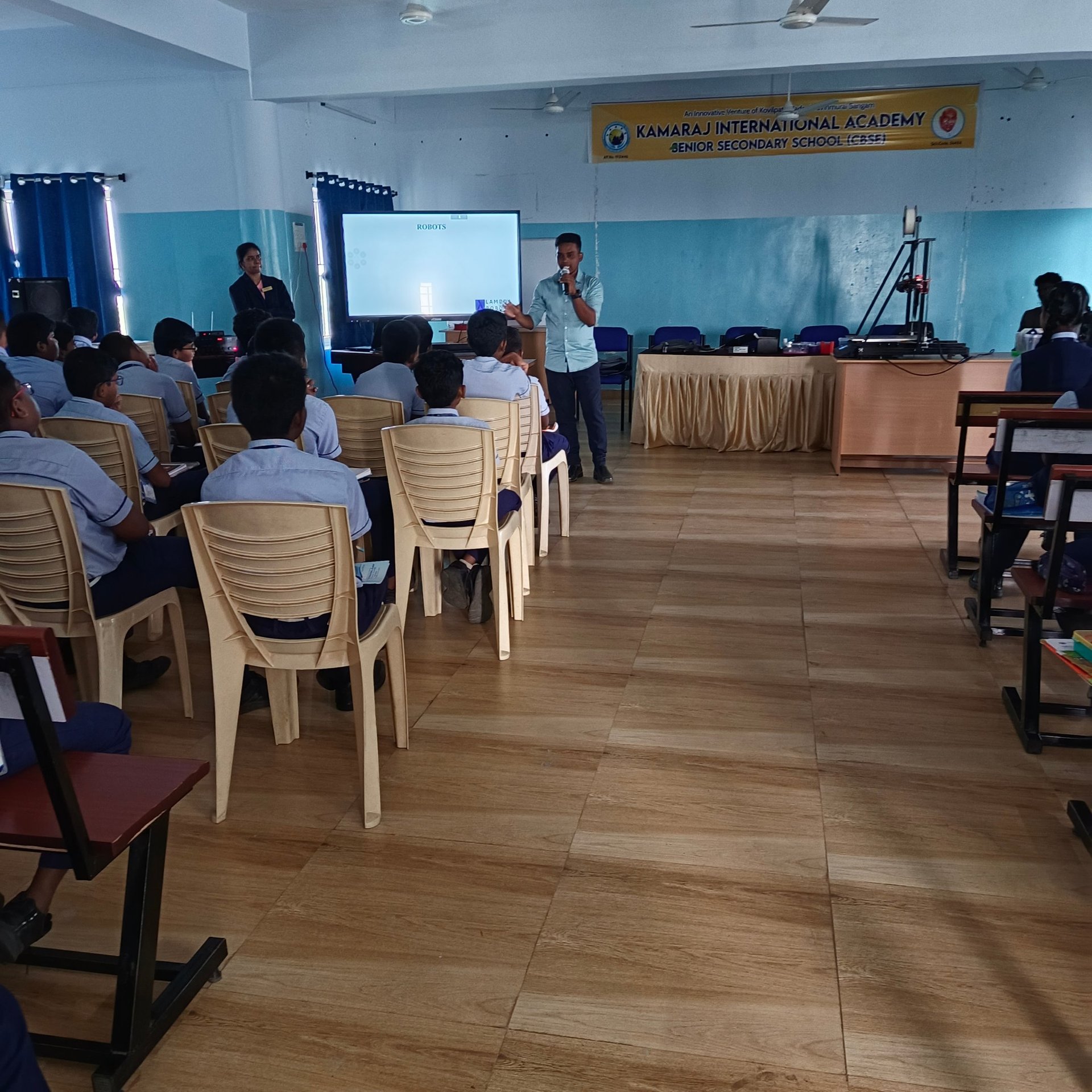 three person sitting in-front of table with laptop computers