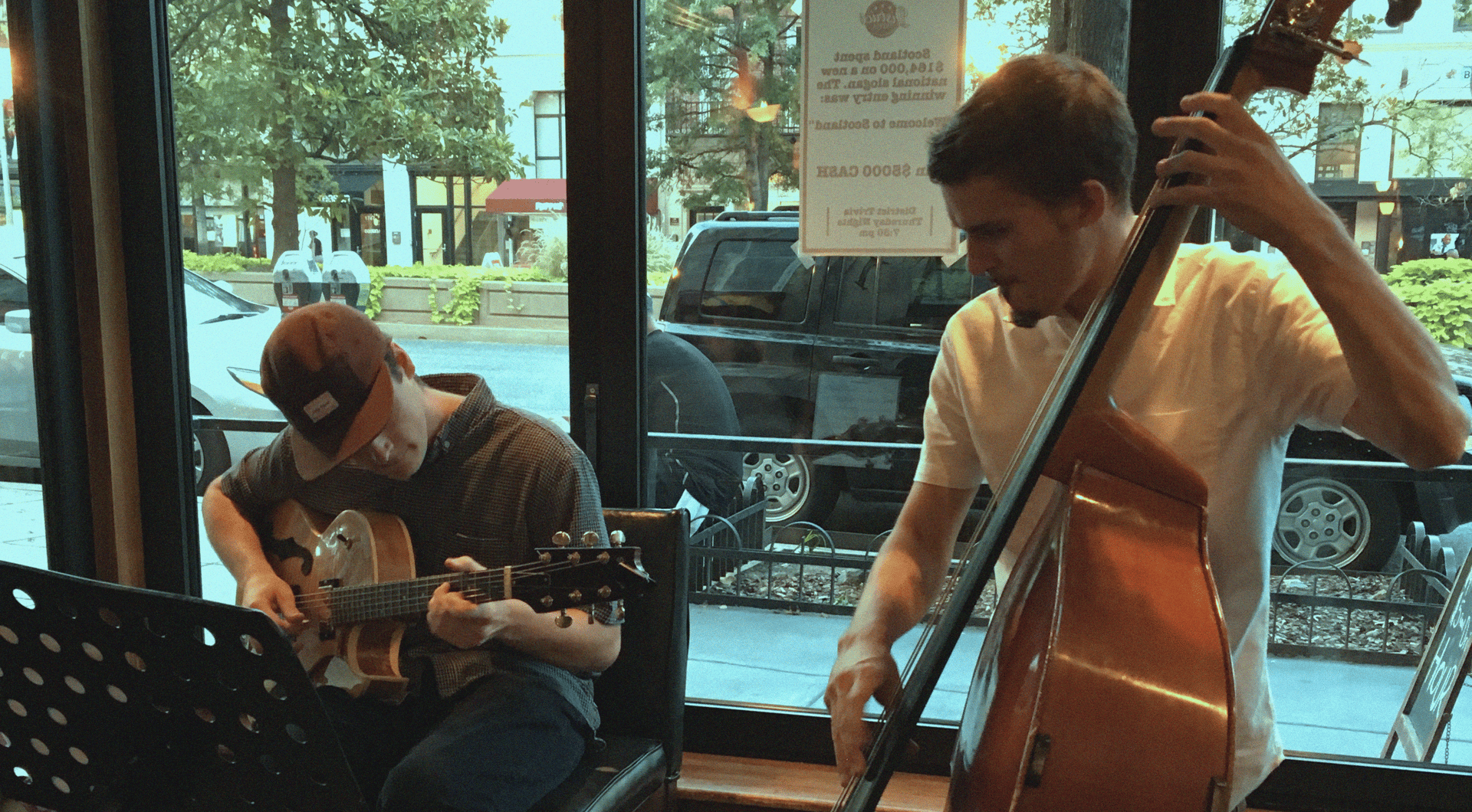 a guitarist and bassist playing in a restaurant