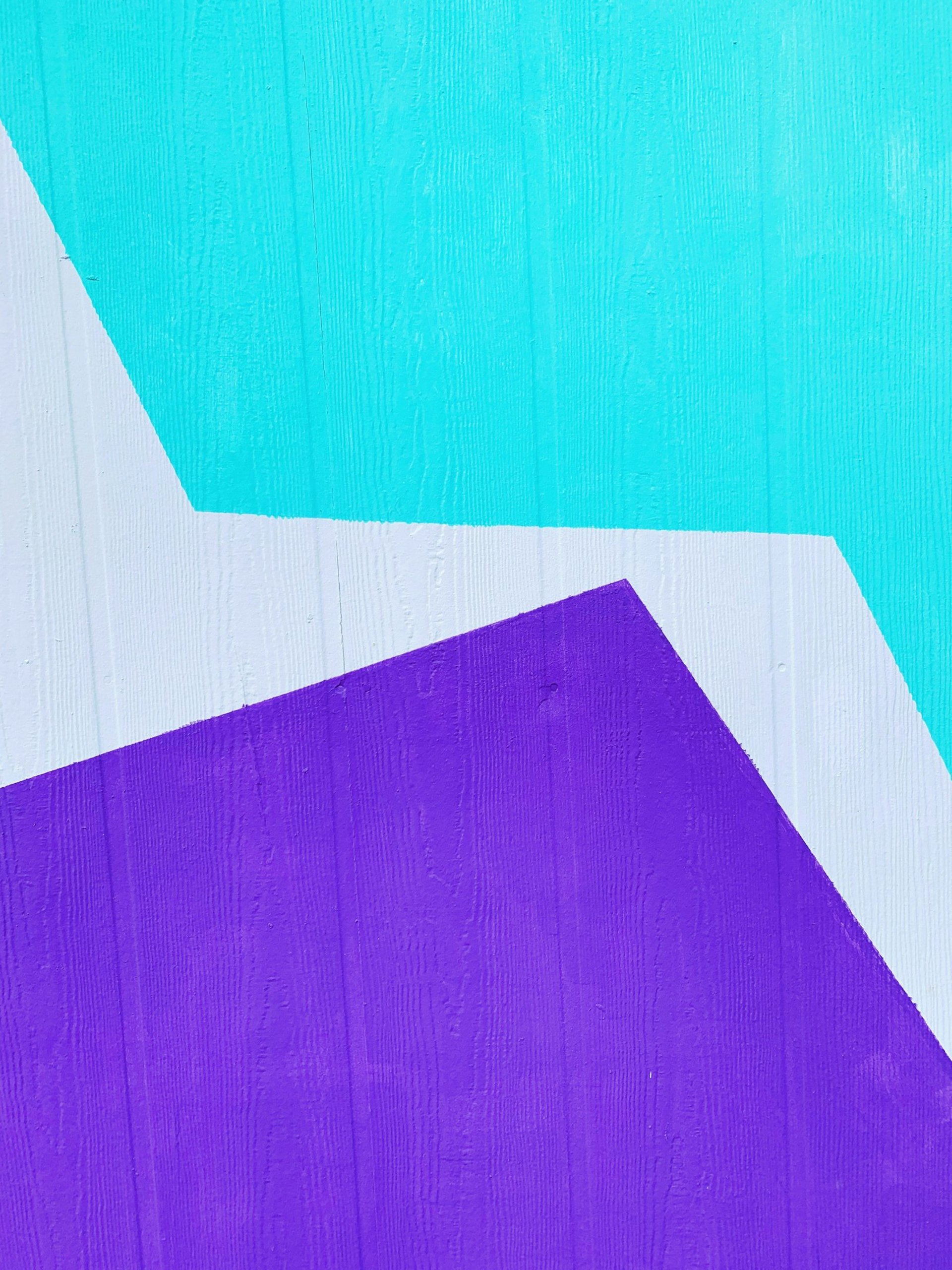 an abstract photo of a curved building with a blue sky in the background