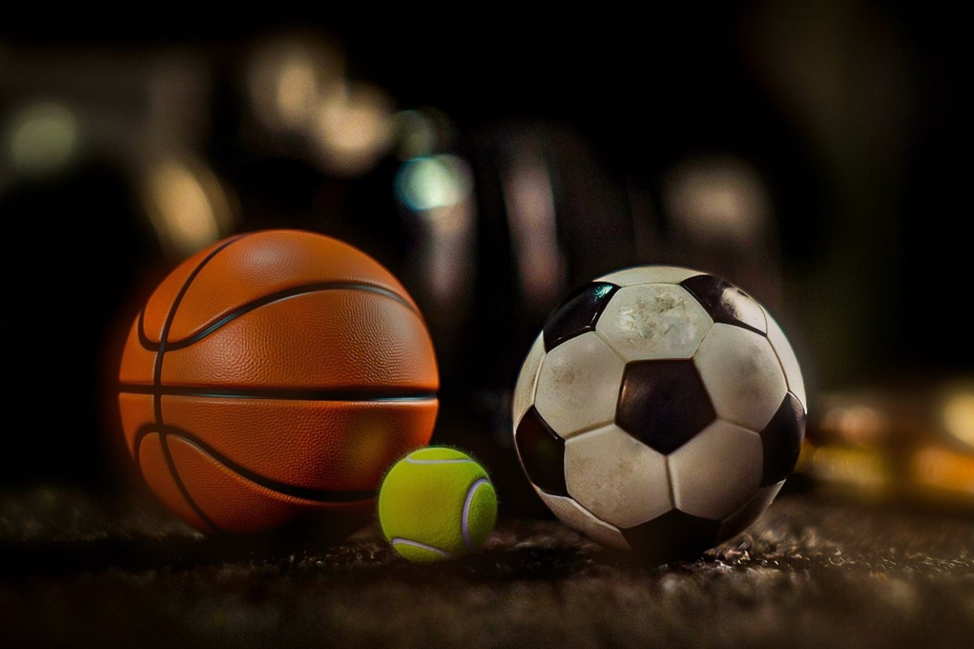 white and black soccer ball on black sand