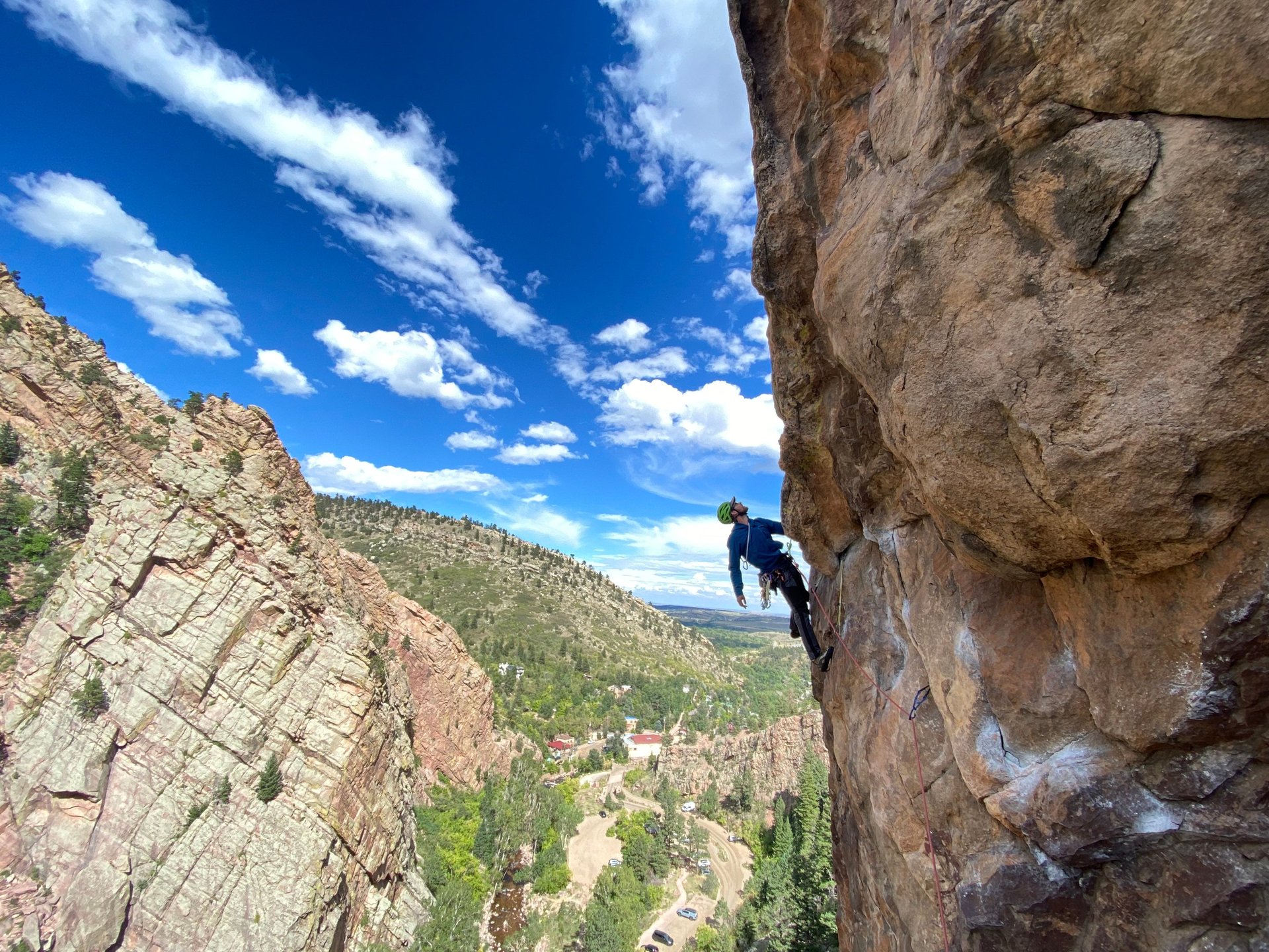 Guide silhouetted while climbing Outer Space in Eldorado canyon.