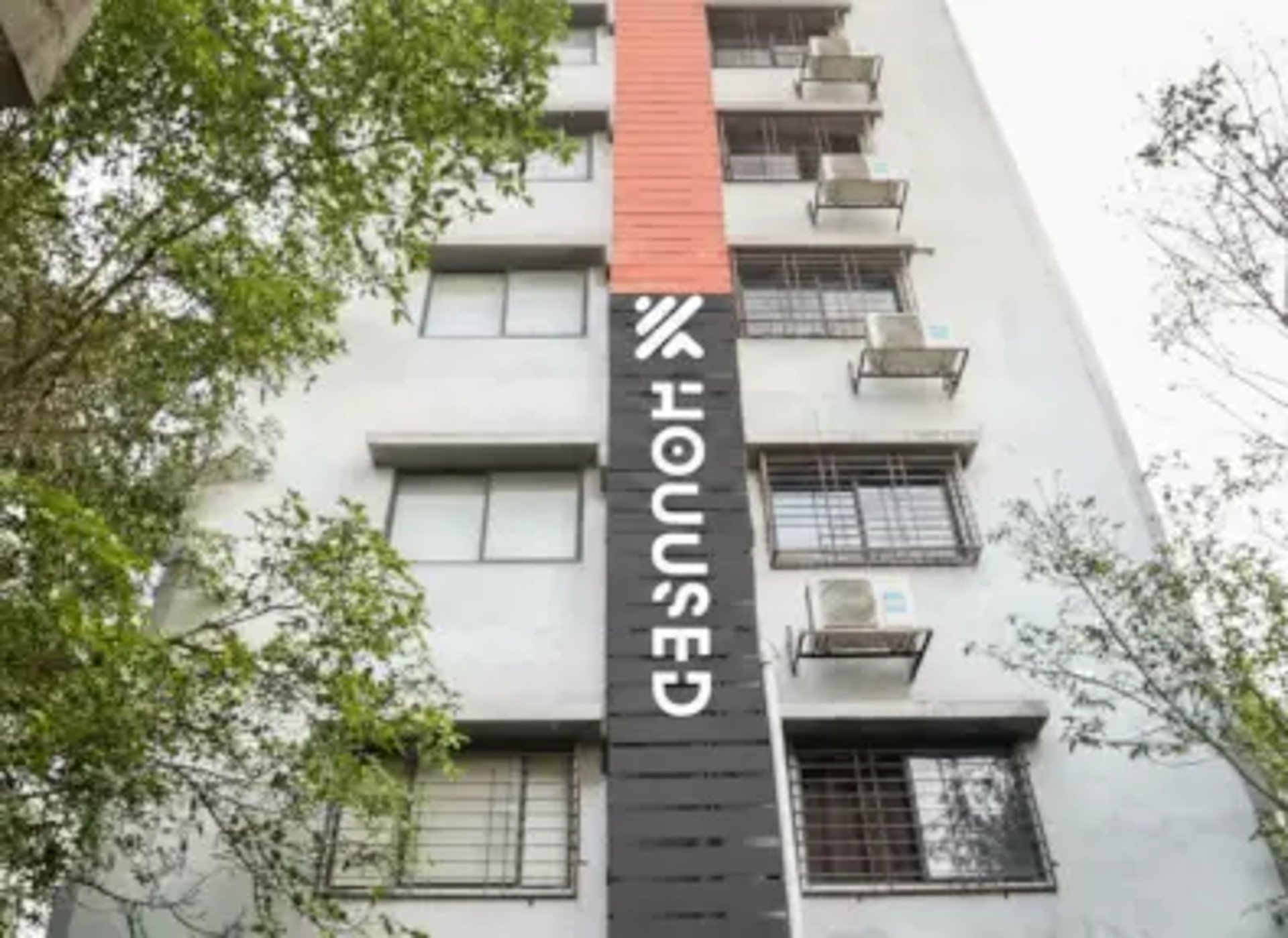 an abstract photo of a curved building with a blue sky in the background