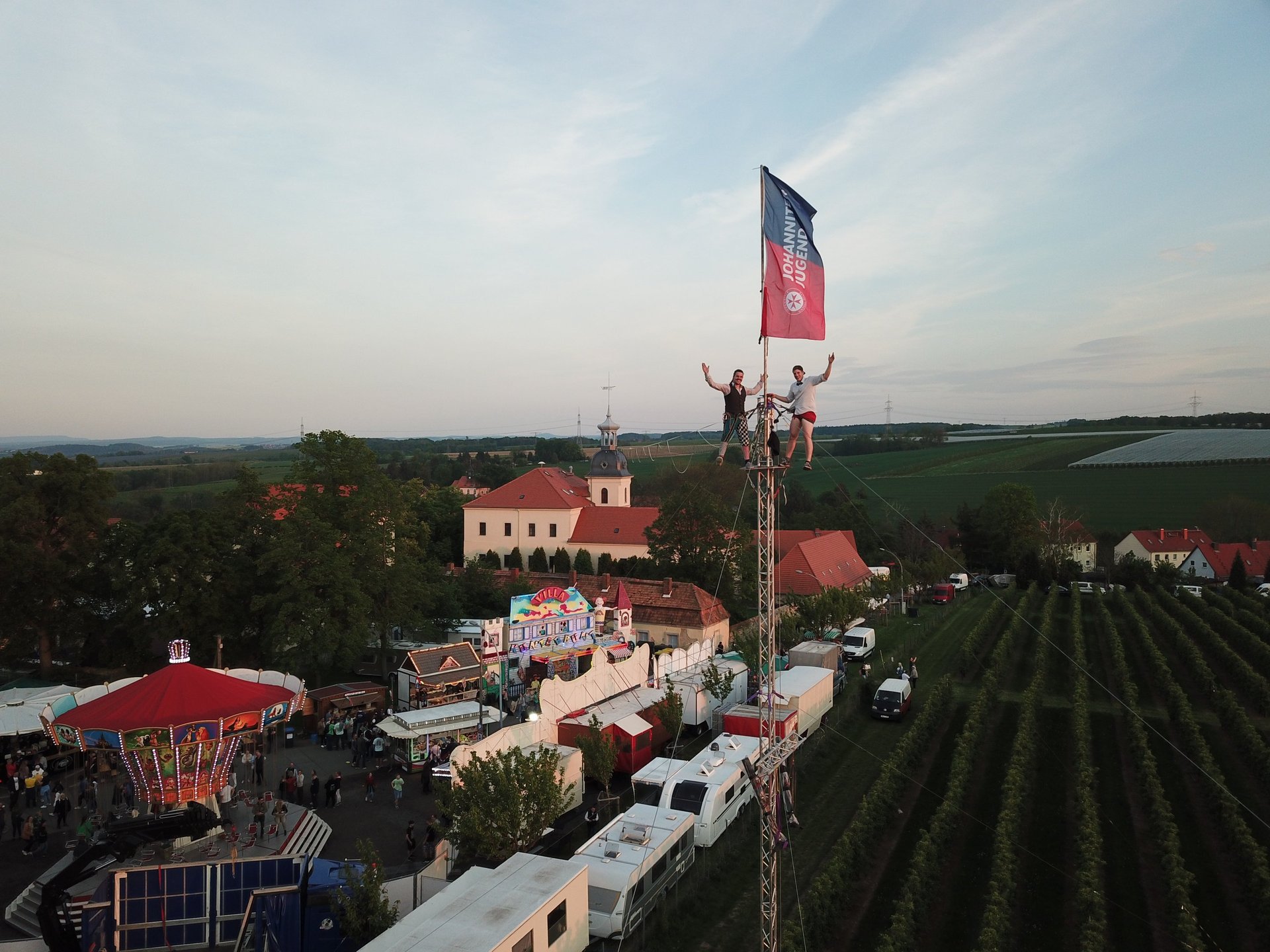 two men in gray hoodies under white clouds