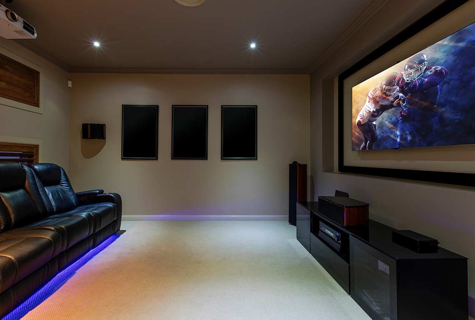 A home theater with two recliners and a flat screen TV