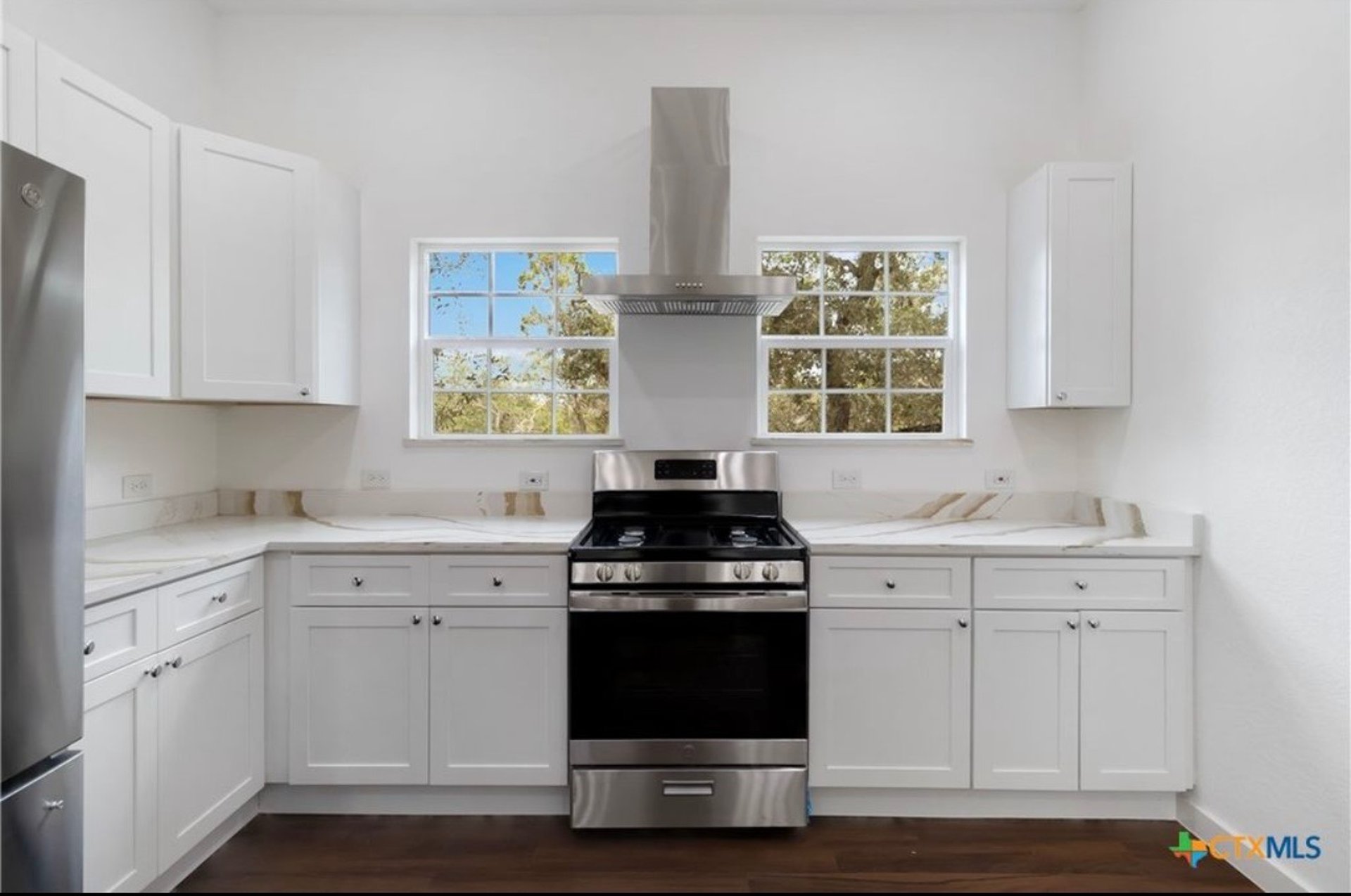 Stainless steel gas stove with dual windows in Hill Country kitchen