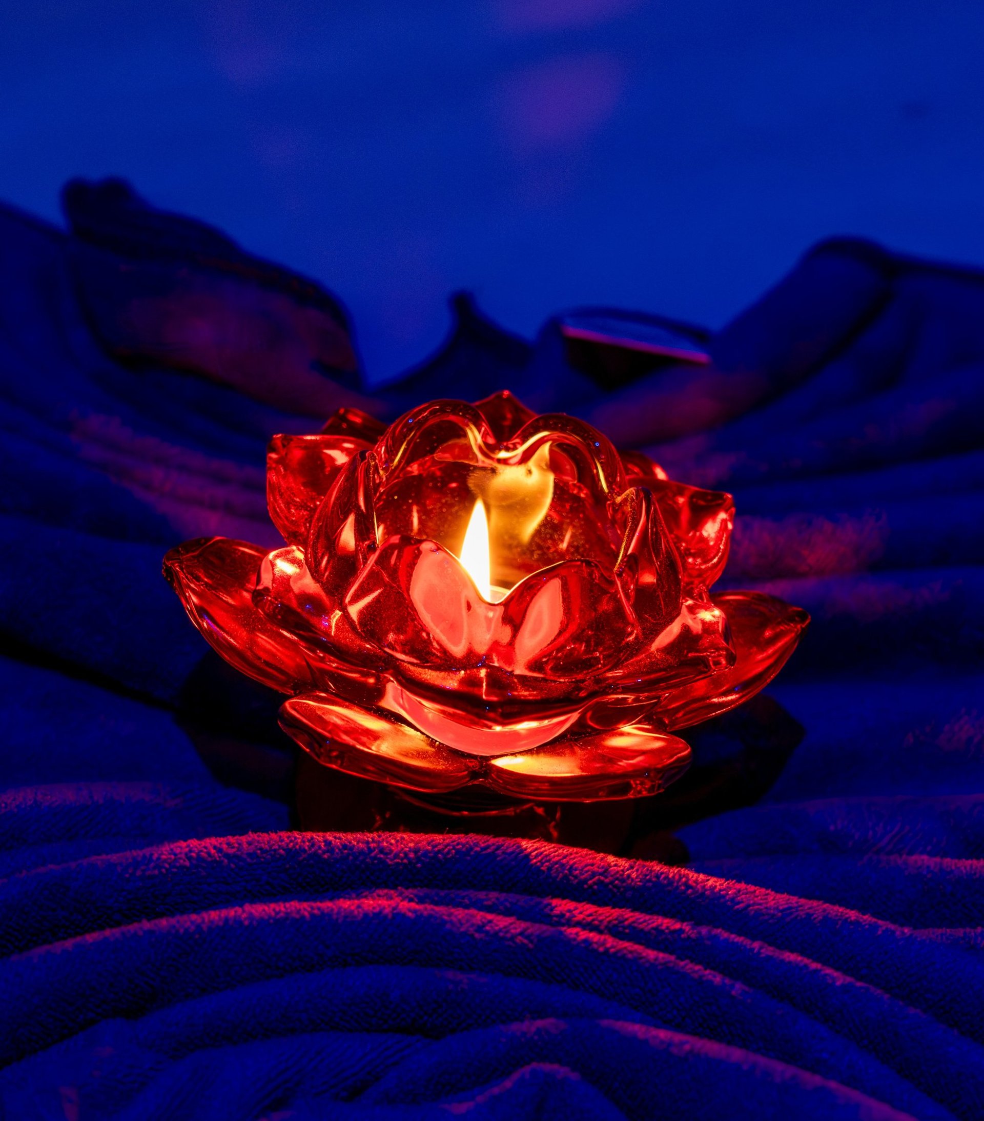 a woman laying on a bed with hot stones on her back