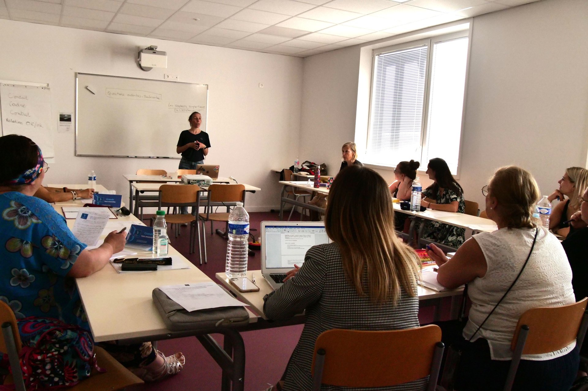 a woman explaining something to a group of people
