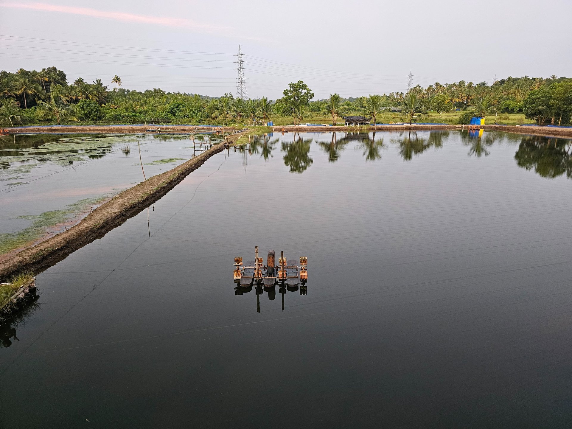Chinese fishing nets at a pier with a boat.
