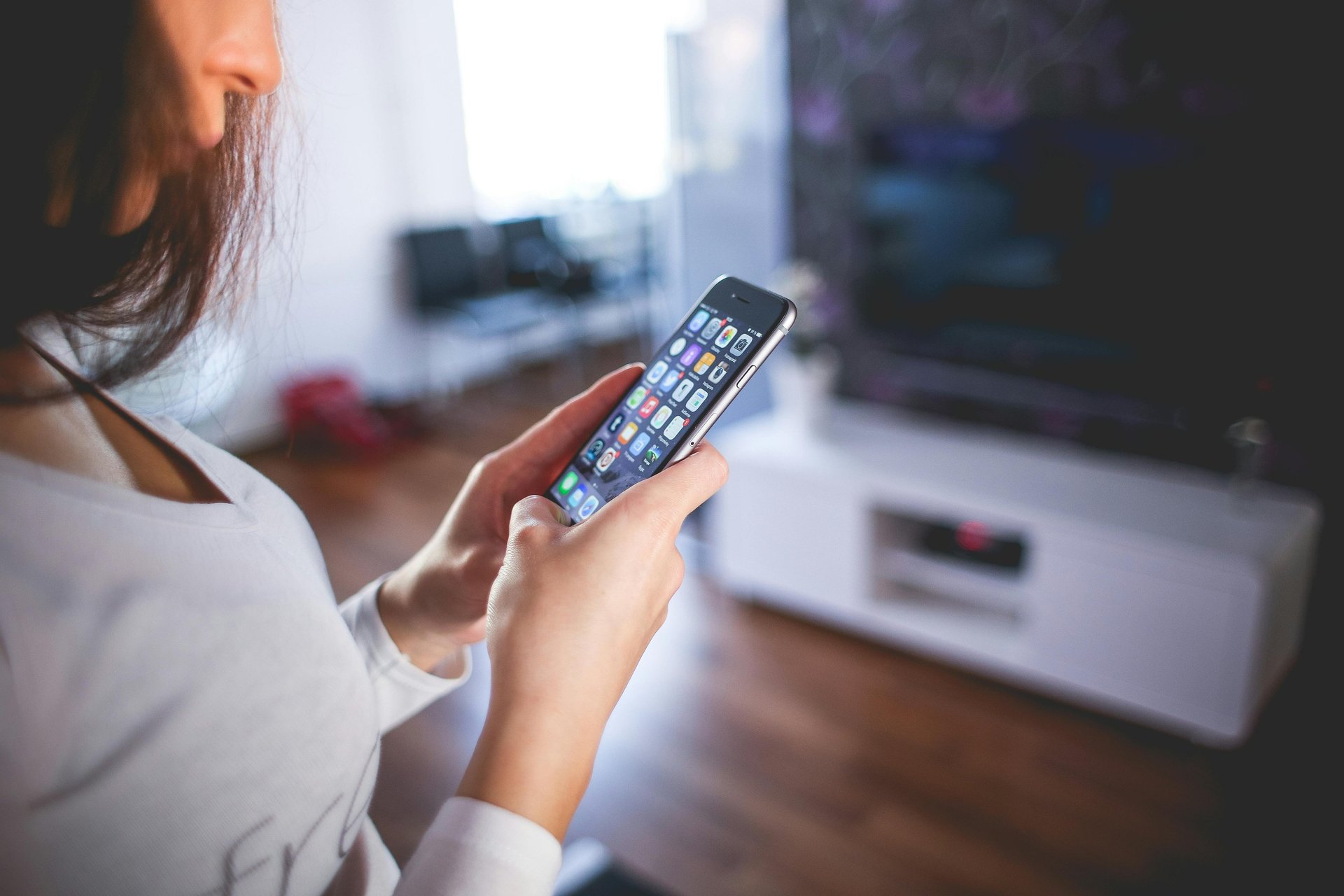 woman holding silver iPhone 6