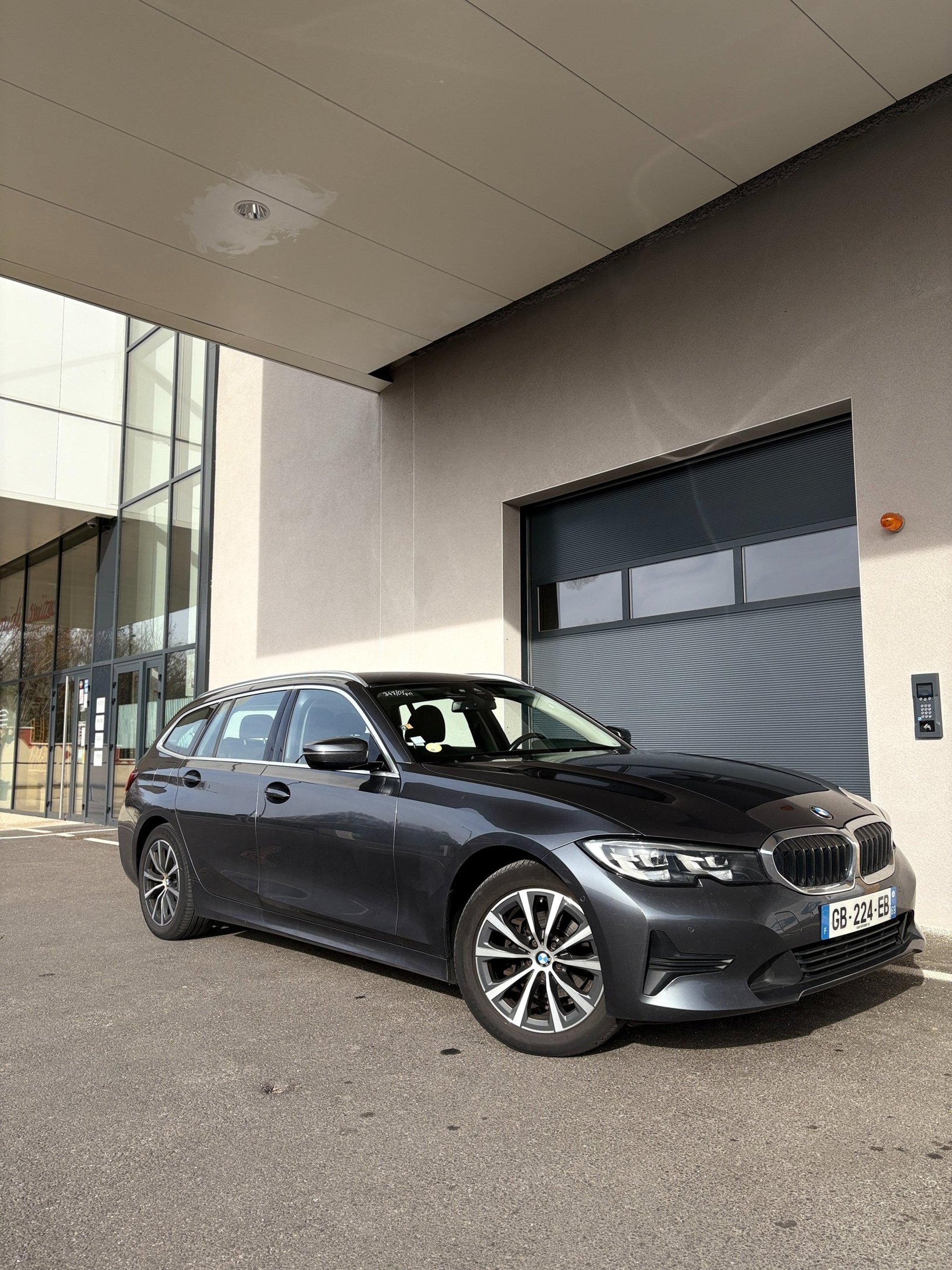 a grey mini cooper parked on the side of the road