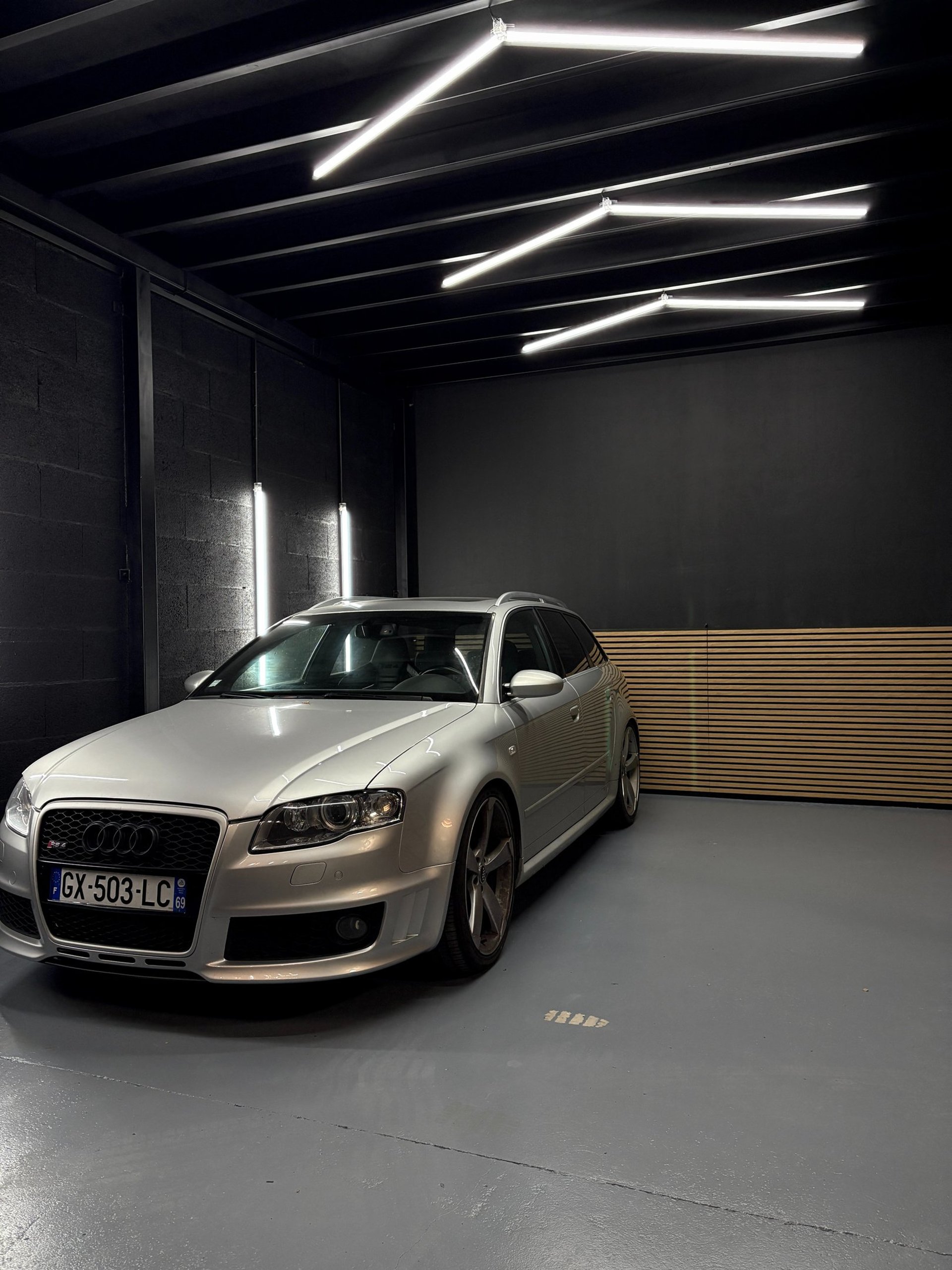 a grey mini cooper parked on the side of the road