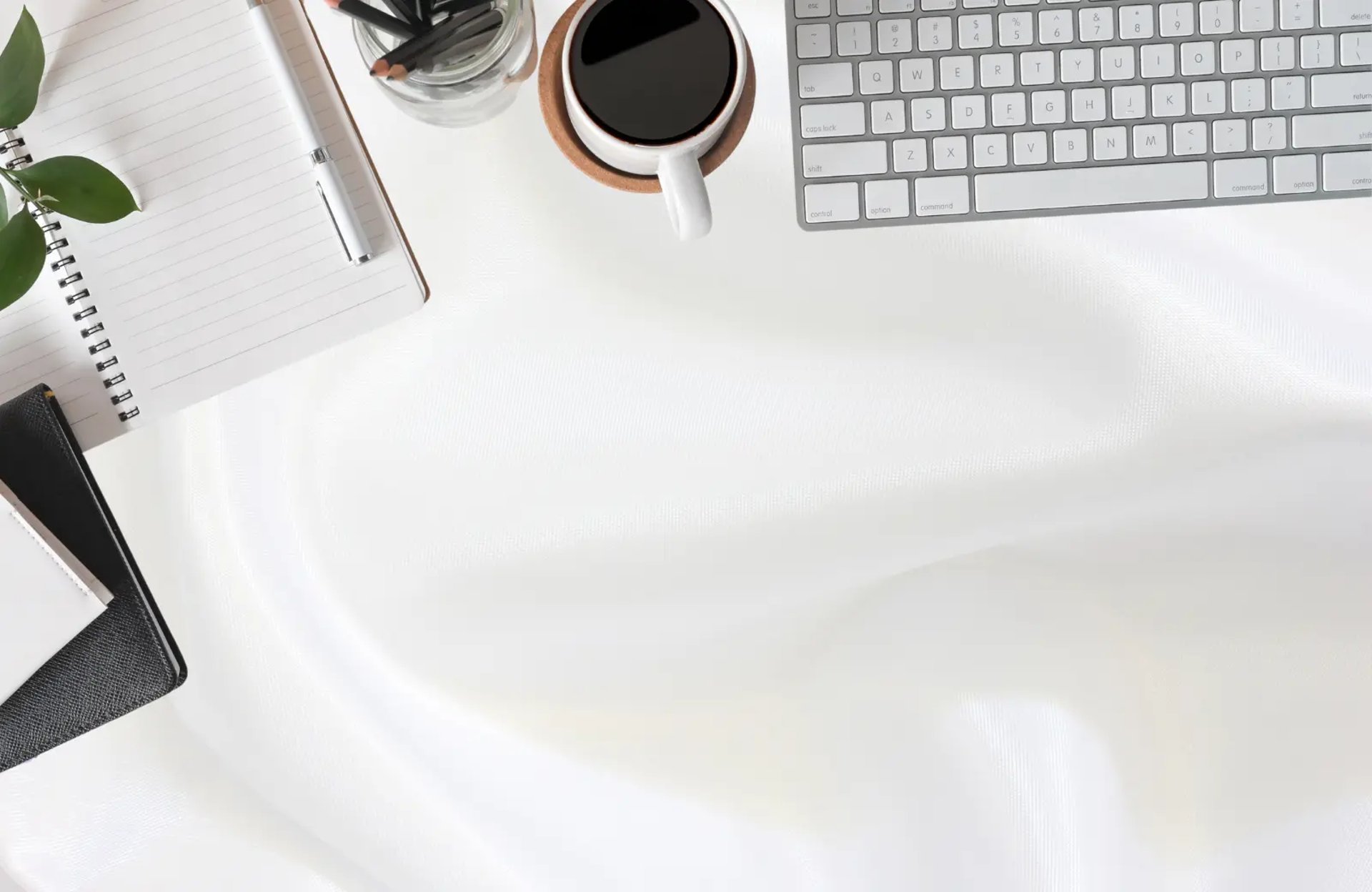Clean office desk setup with keyboard, notebook, and coffee, representing Zamora Marketing’s professional web design services