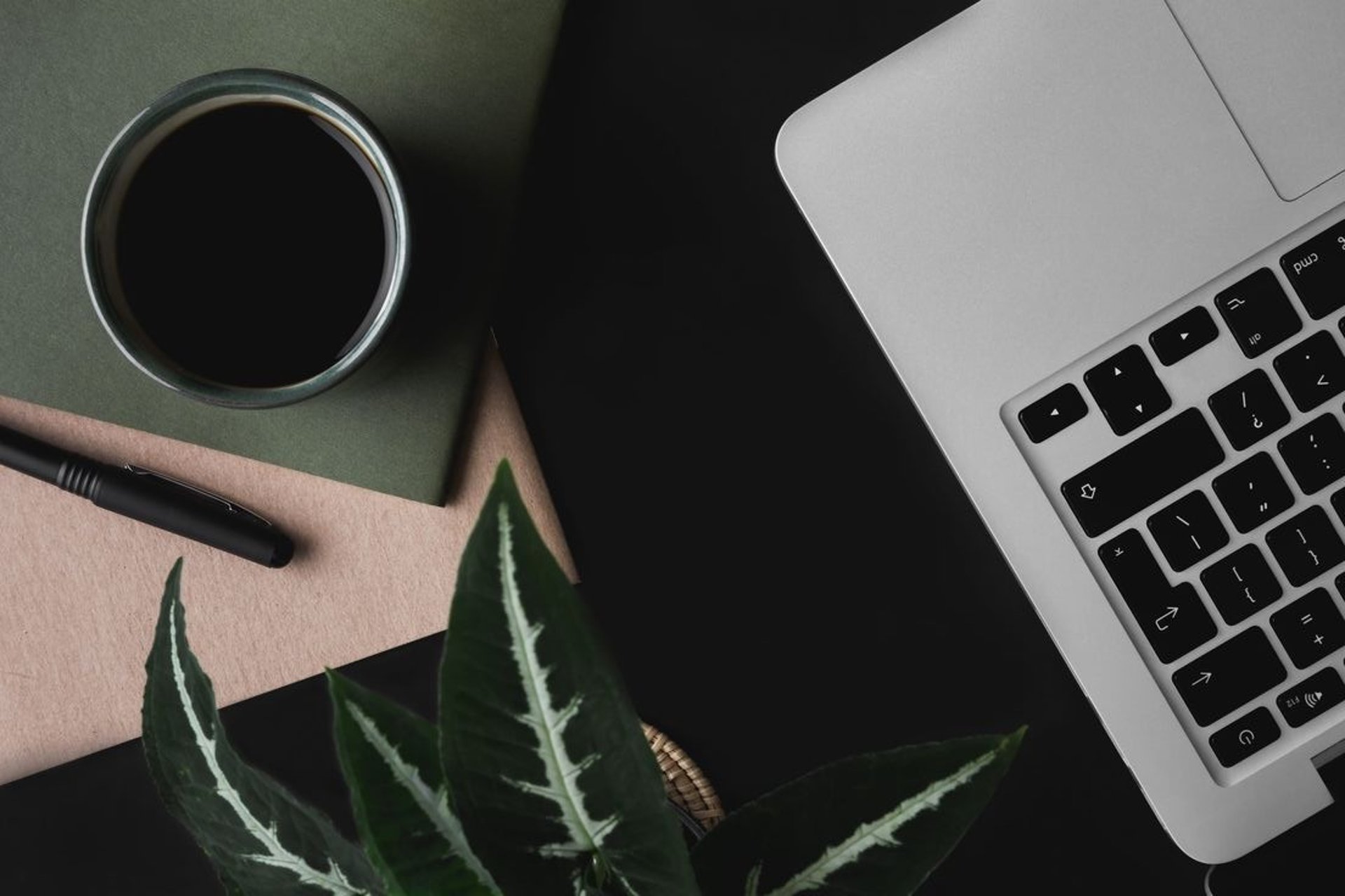 cup of coffee near MacBook Pro