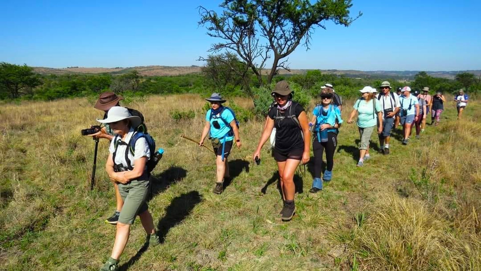 two person walking towards mountain covered with snow