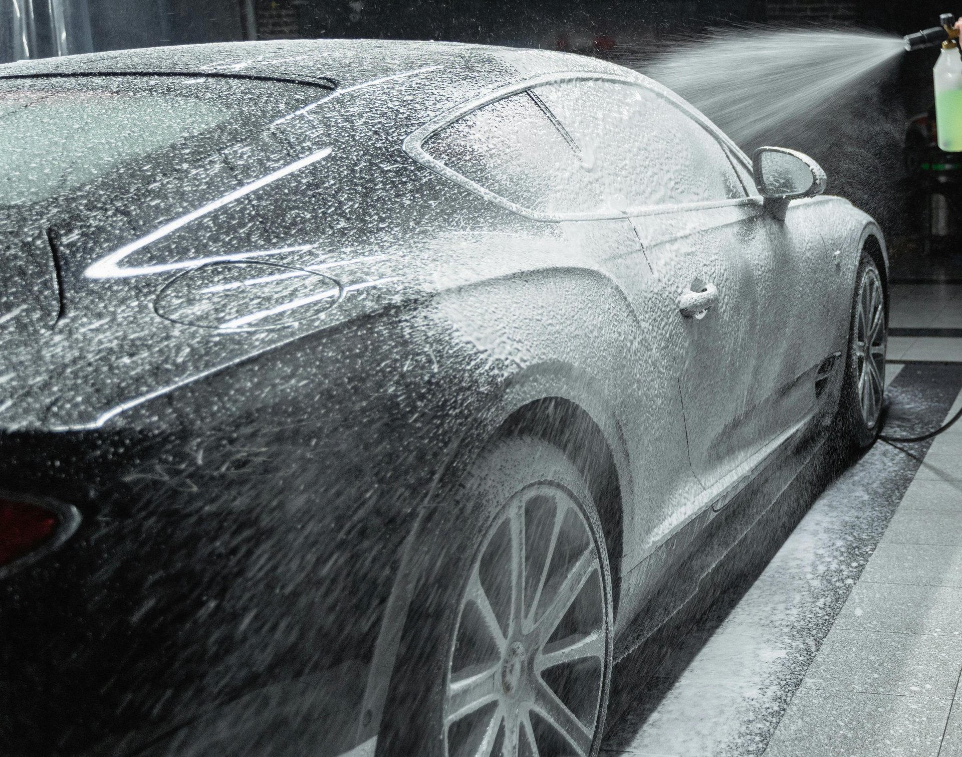 a black car is parked in a garage