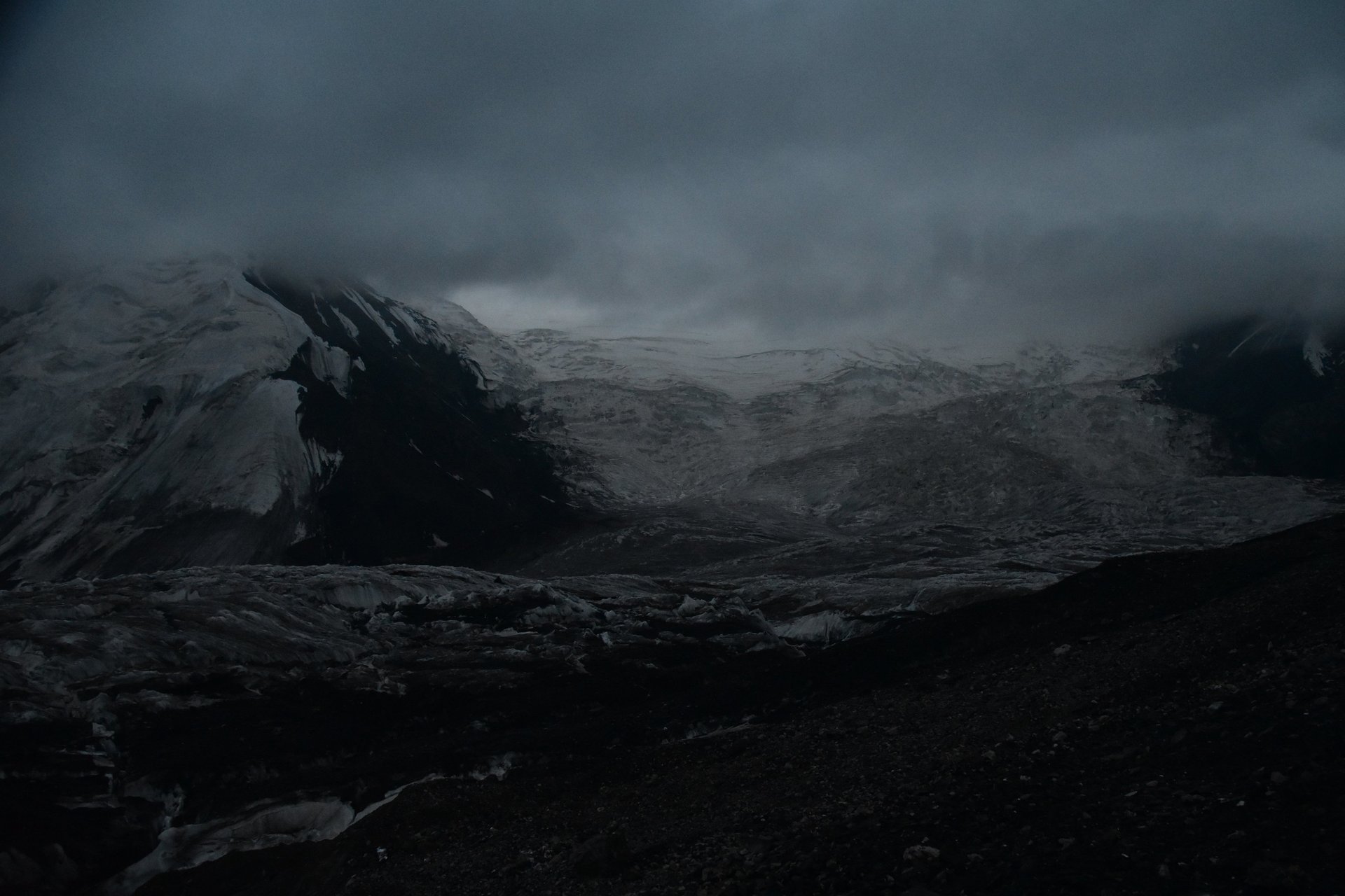 Vast glacier with textured icy surface and mountains