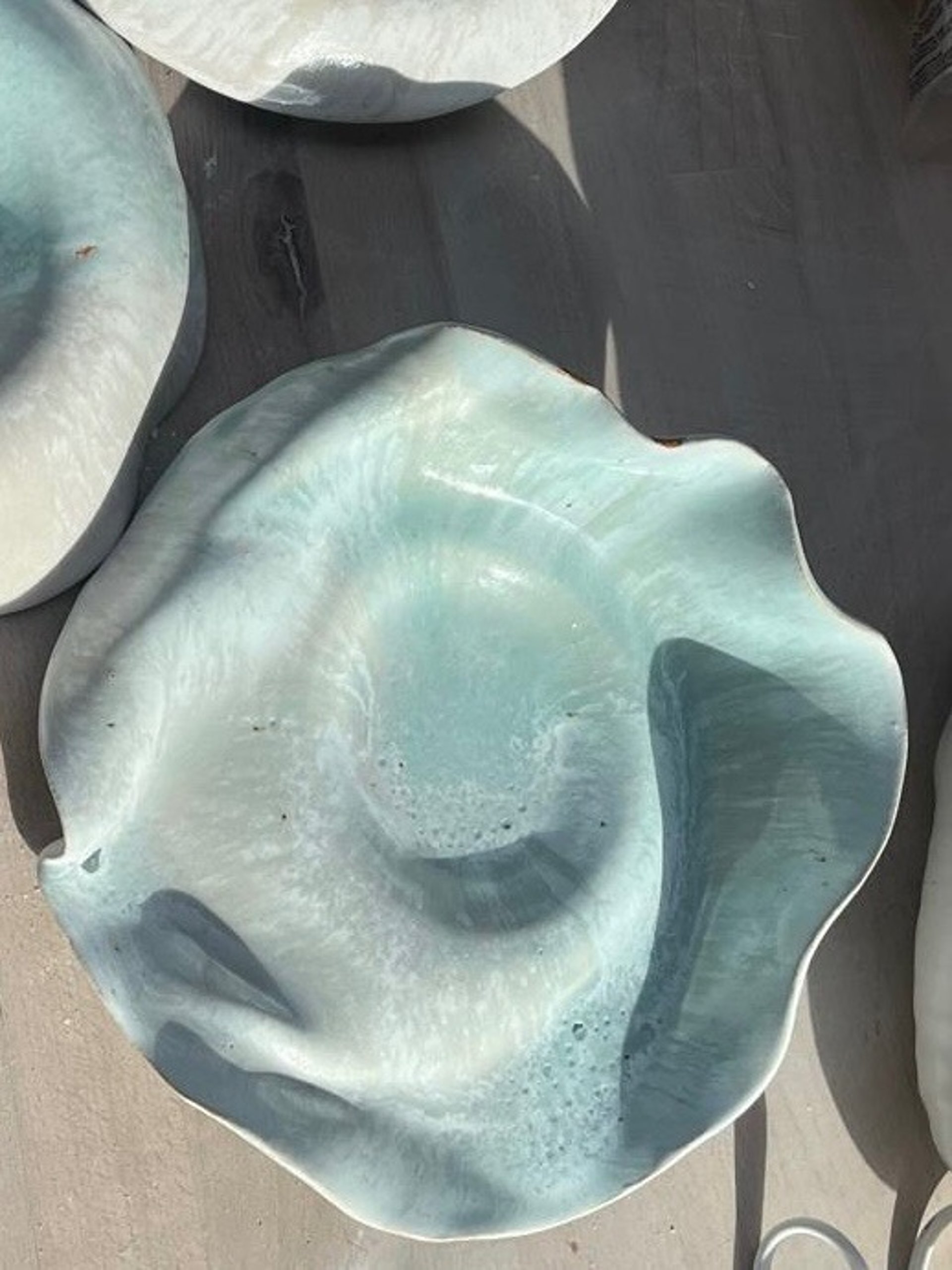 a person pouring tea into a cup on a tray