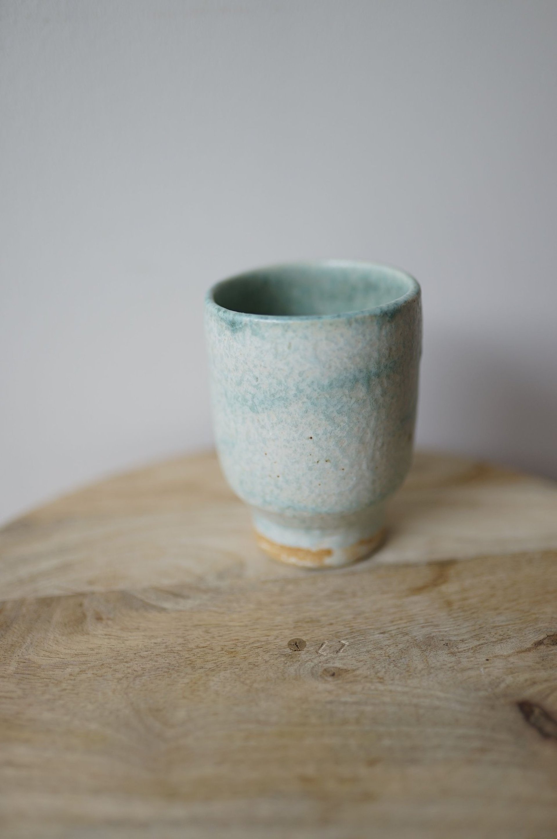 a person pouring tea into a cup on a tray