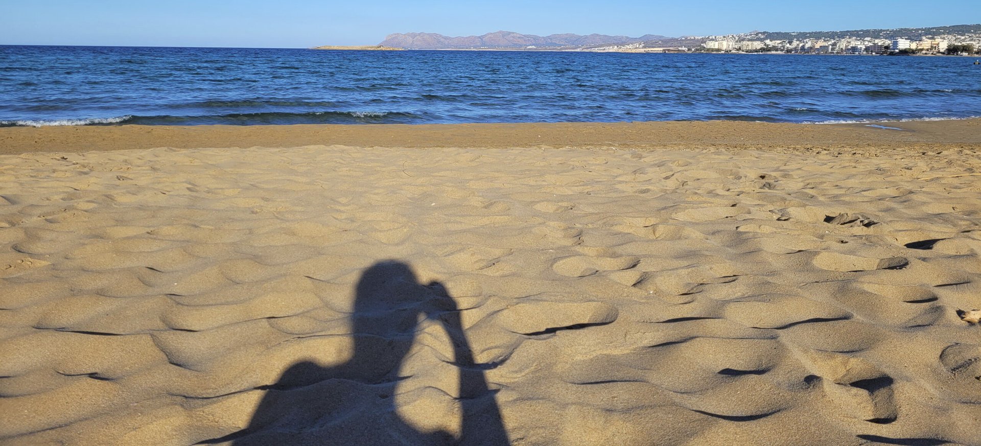 an abstract photo of a curved building with a blue sky in the background