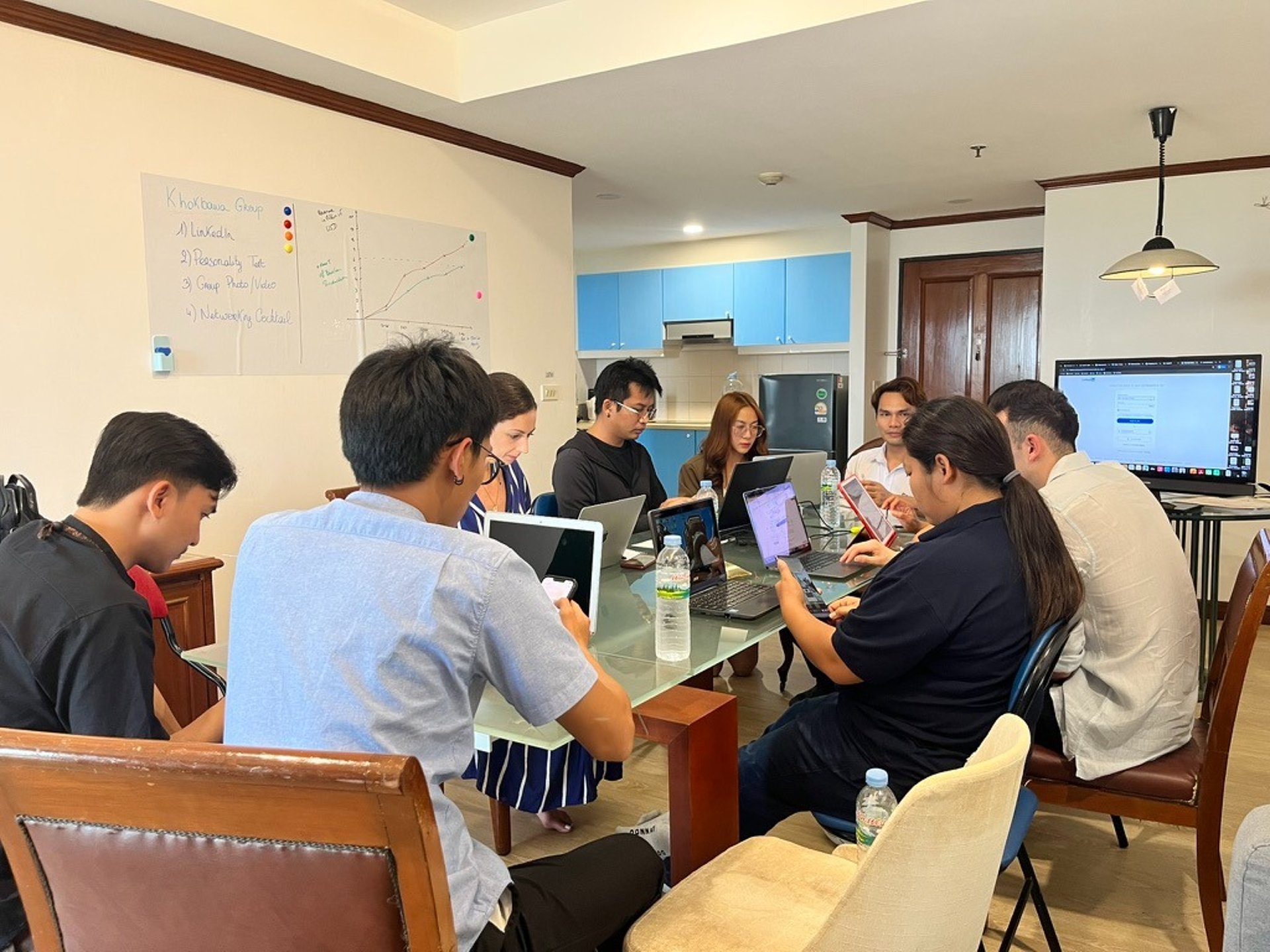 selective focus photography of people sits in front of table inside room
